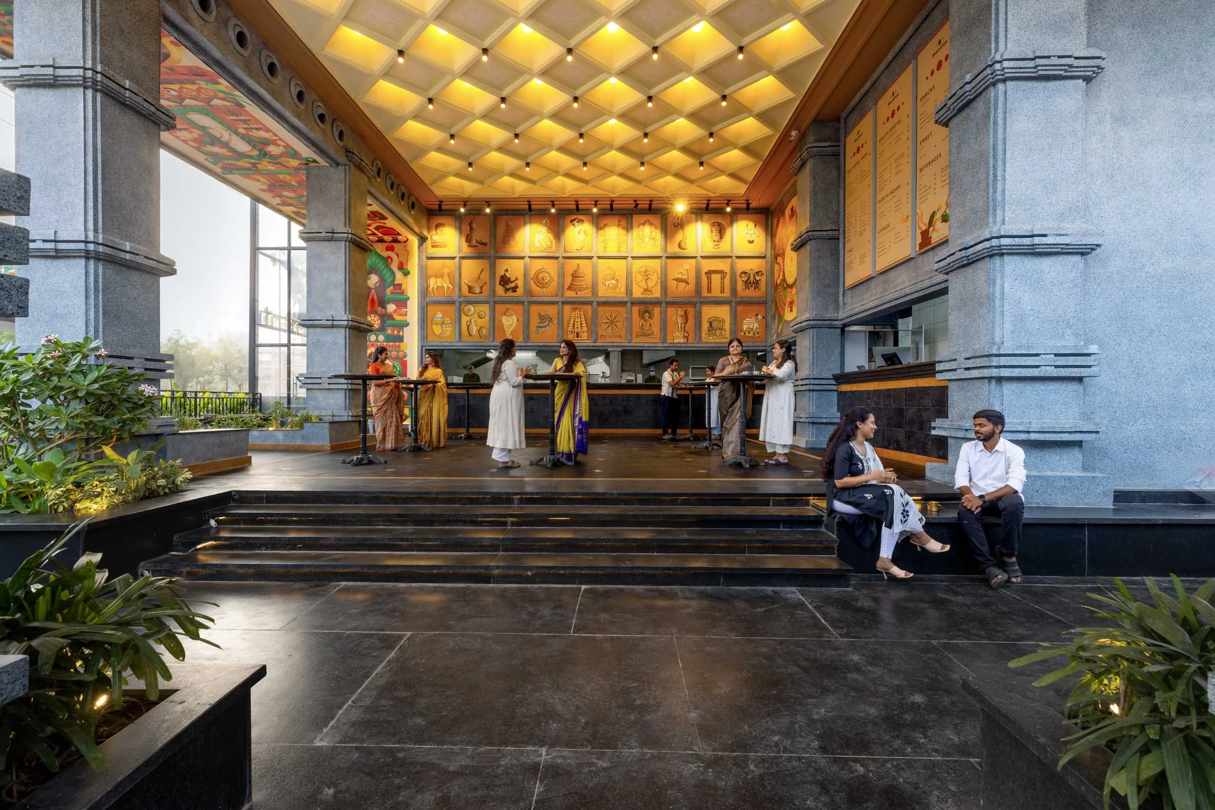 Commercial interior photography showcasing a luxury hotel or restaurant entrance, highlighting grand lobby architecture, custom geometric ceiling design, and upscale hospitality interior