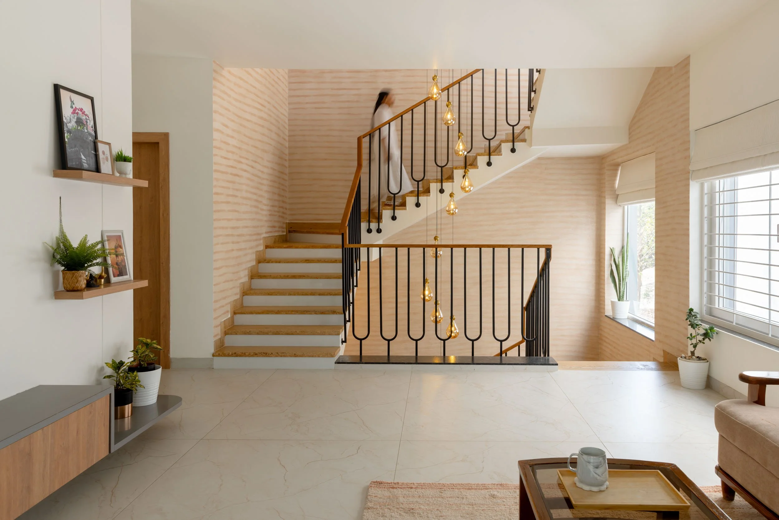 Professional interior architectural photography of a modern, open-plan residential home featuring a split-level layout and abundant natural light