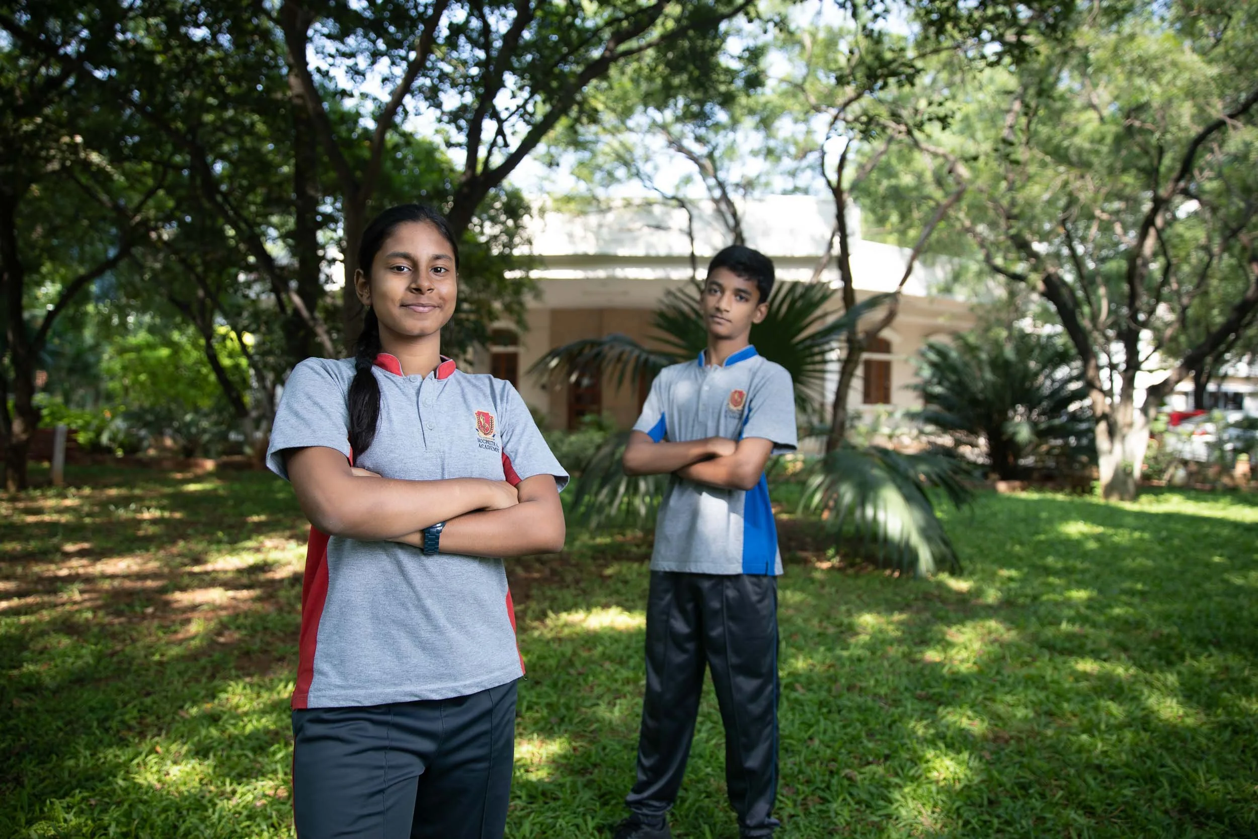Exterior school photography of students standing in a lush green campus garden | Ravi Varma Photography & Films