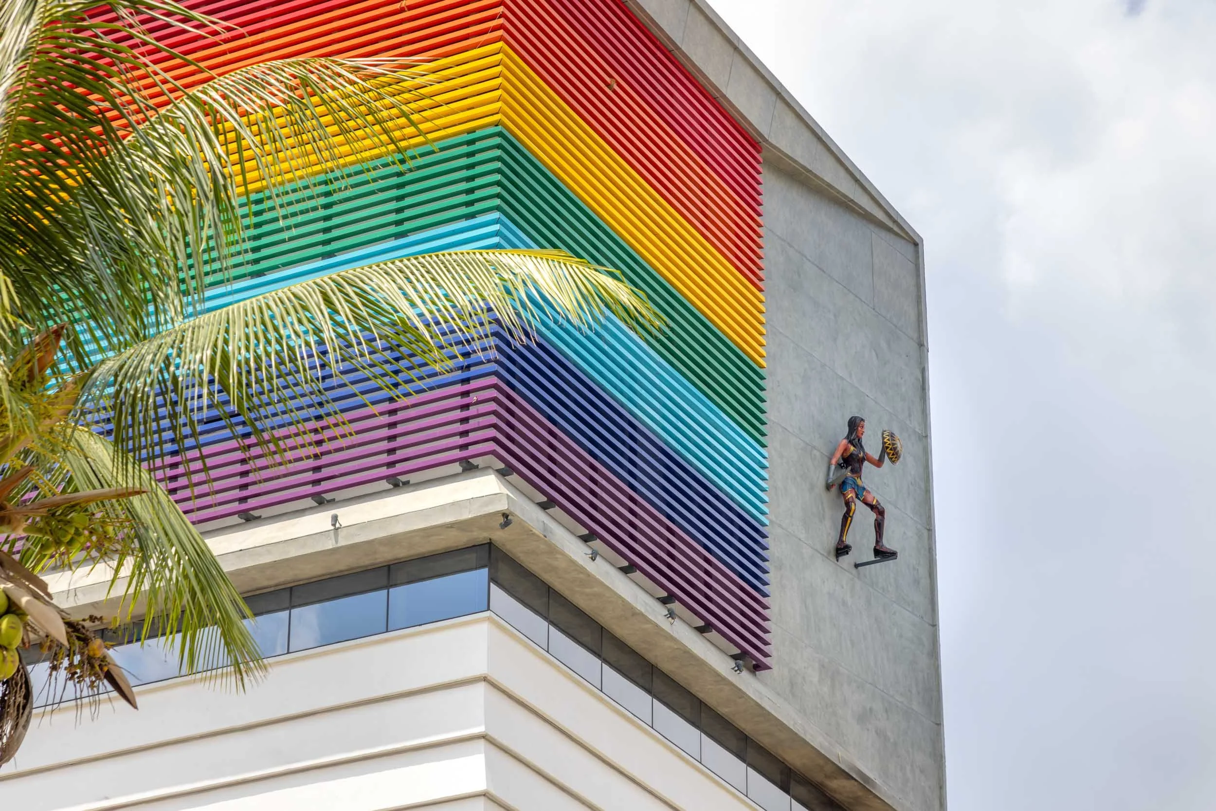 Exterior commercial architecture photography showcasing a modern office building with vibrant, colorful facade accents and expansive glass windows