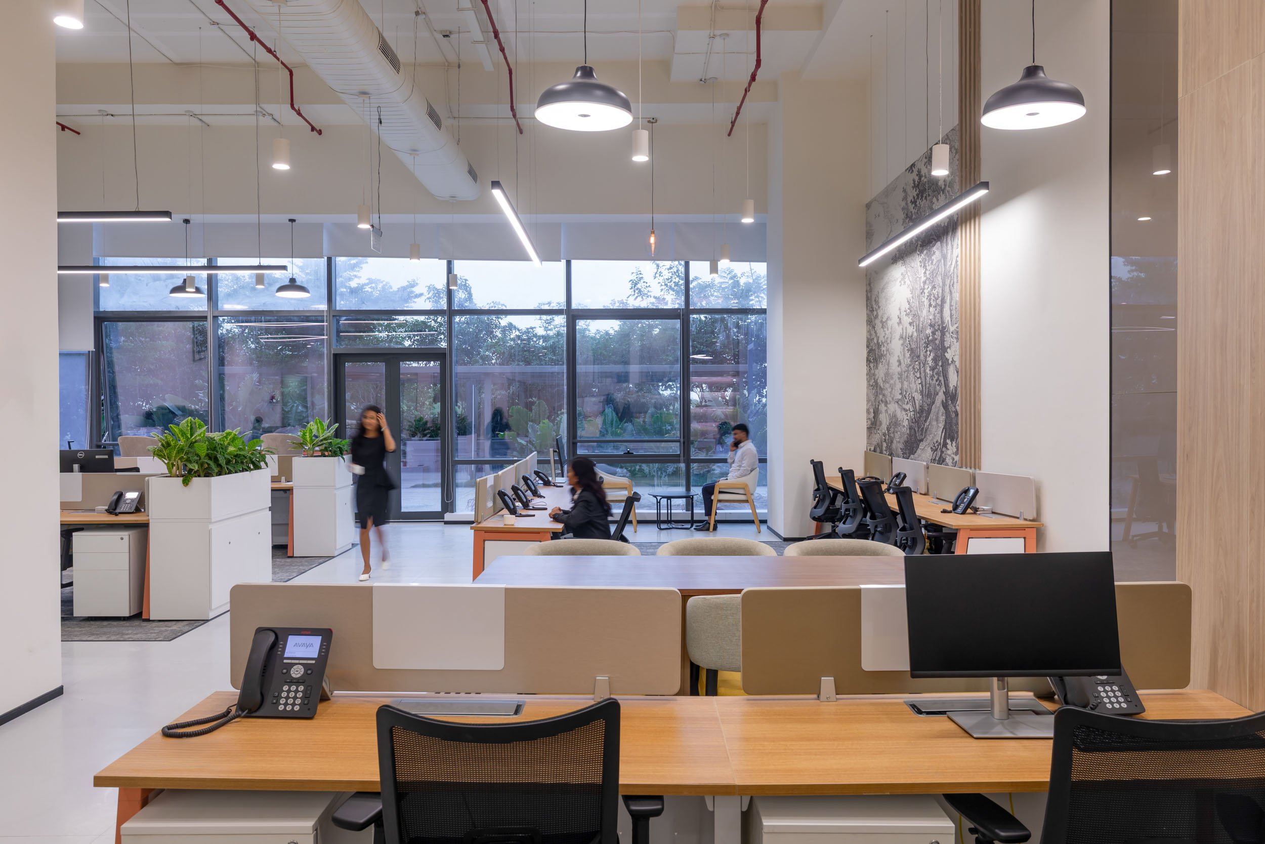 Commercial interior photography showcasing a spacious, modern corporate office, highlighting open collaborative workspaces, natural lighting, and contemporary interior design
