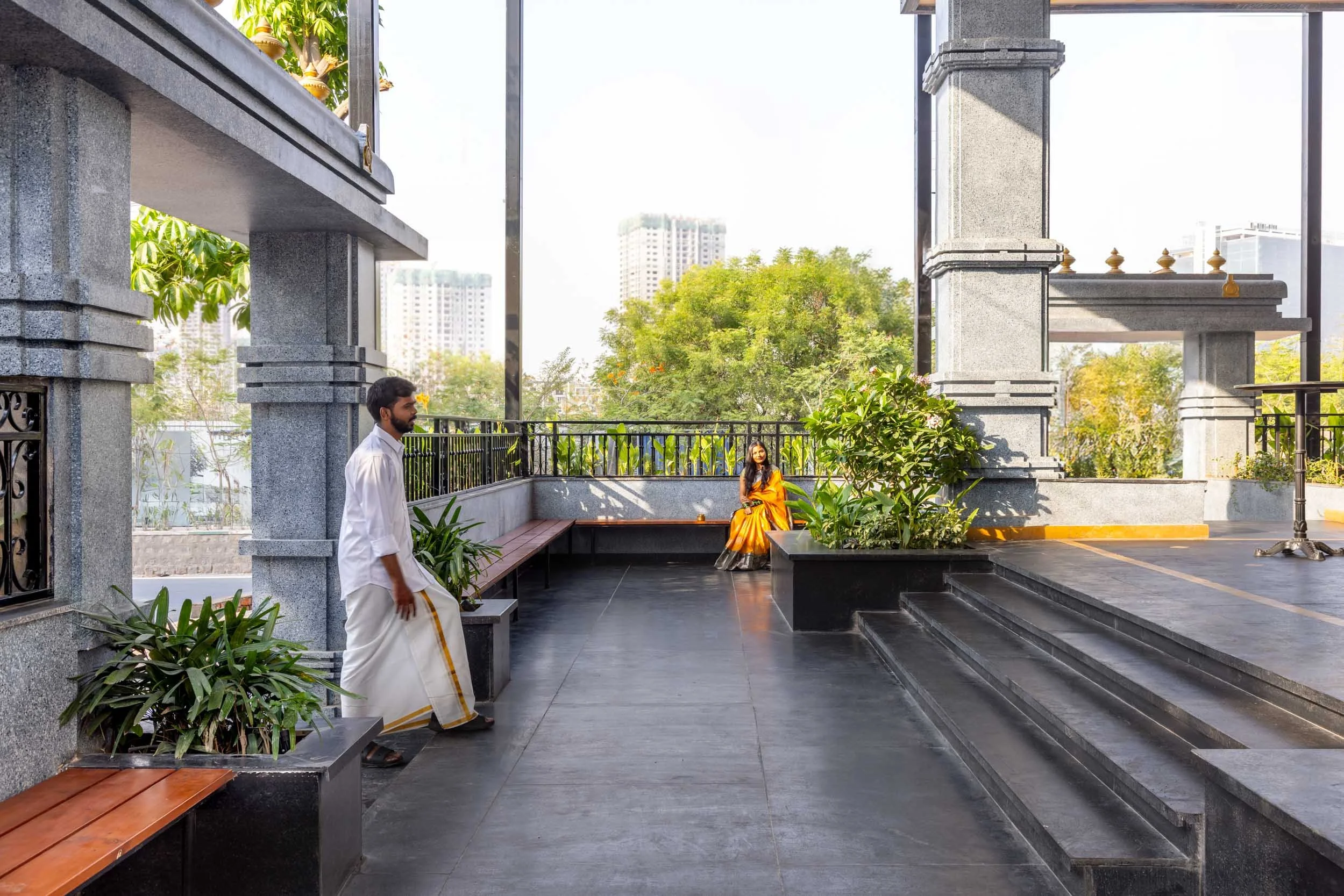 Commercial architectural and lifestyle photography showcasing a modern hospitality outdoor space, highlighting exterior walkway design, landscape integration, and al fresco restaurant environments