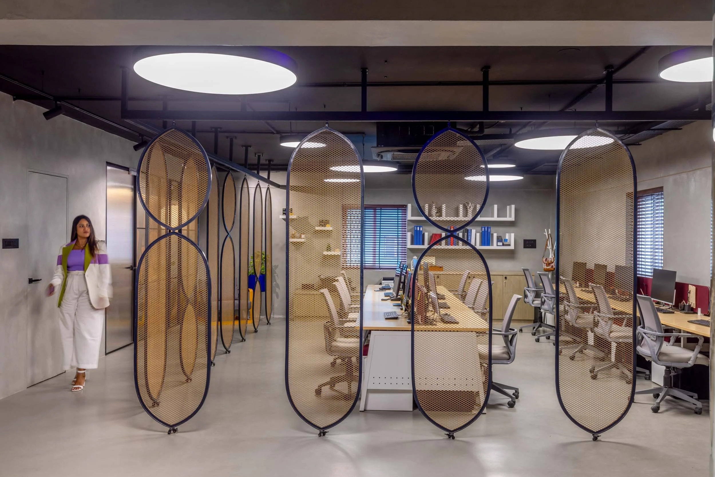 Commercial interior photography showcasing a modern corporate workspace, highlighting innovative architectural dividers, open-plan desk arrangements, and contemporary office design