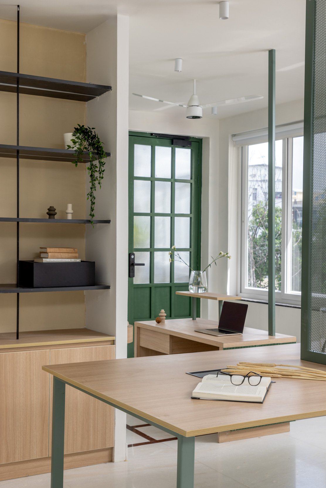 Commercial interior photography of a modern corporate breakout space, highlighting industrial design elements, casual lounge seating, and an active workspace environment