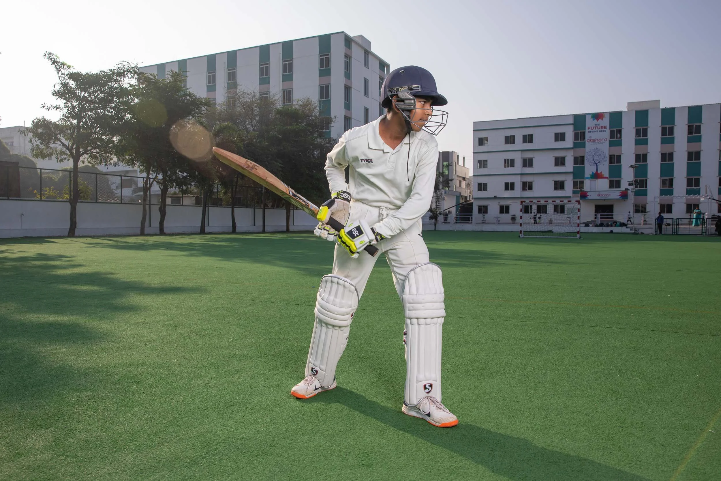 Exterior campus photography highlighting student sports and a cricket match on the school grounds | Ravi Varma Photography & Films