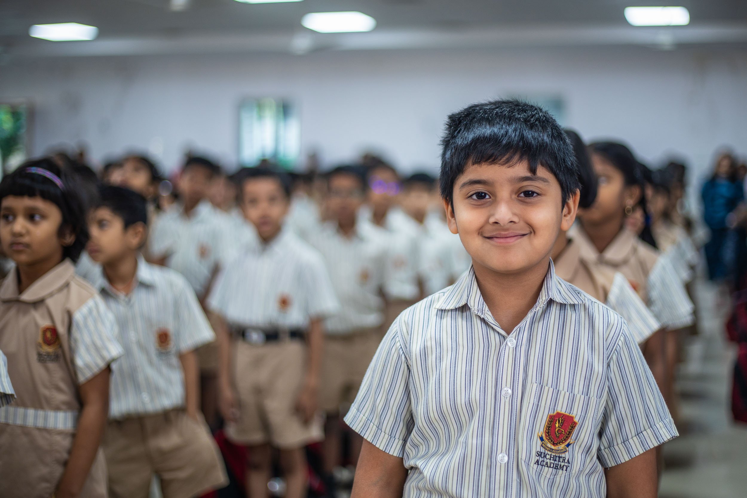Interior school photography of elementary students smiling in a modern classroom | Ravi Varma Photography & Films