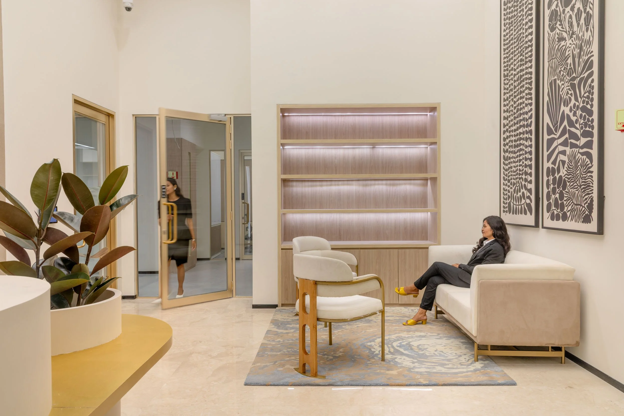 Commercial interior photography showcasing a modern corporate lounge and reception space, highlighting contemporary design, natural light, and comfortable seating