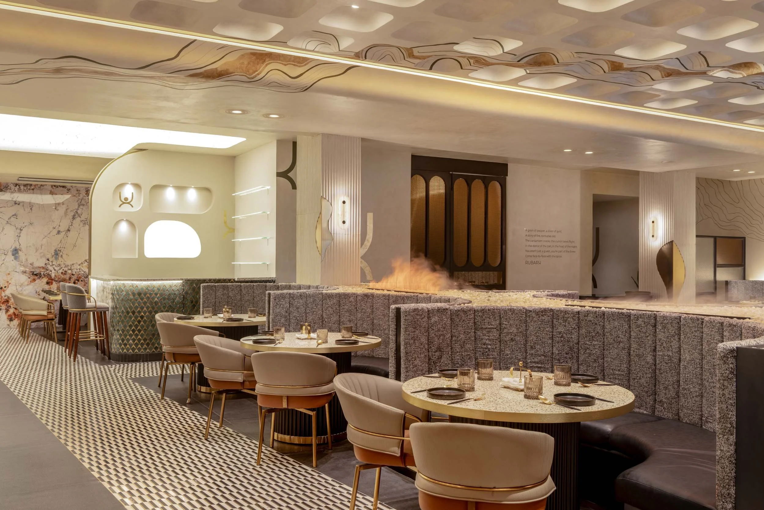 Commercial interior photography showcasing a luxury restaurant dining room, highlighting custom booth seating, textured architectural wall panels, and unique ceiling design in hospitality spaces