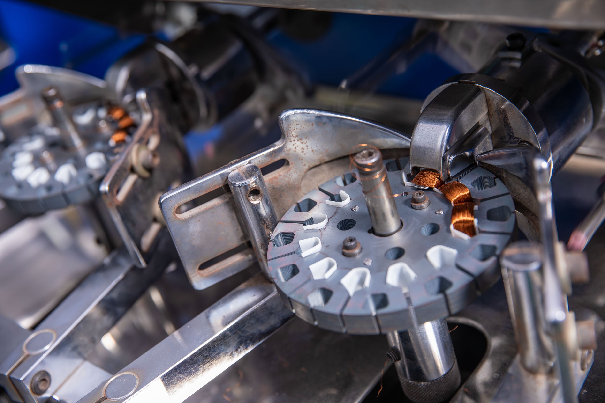 Close-up industrial photography of a complex rotary mechanism on an automated processing machine in a manufacturing facility
