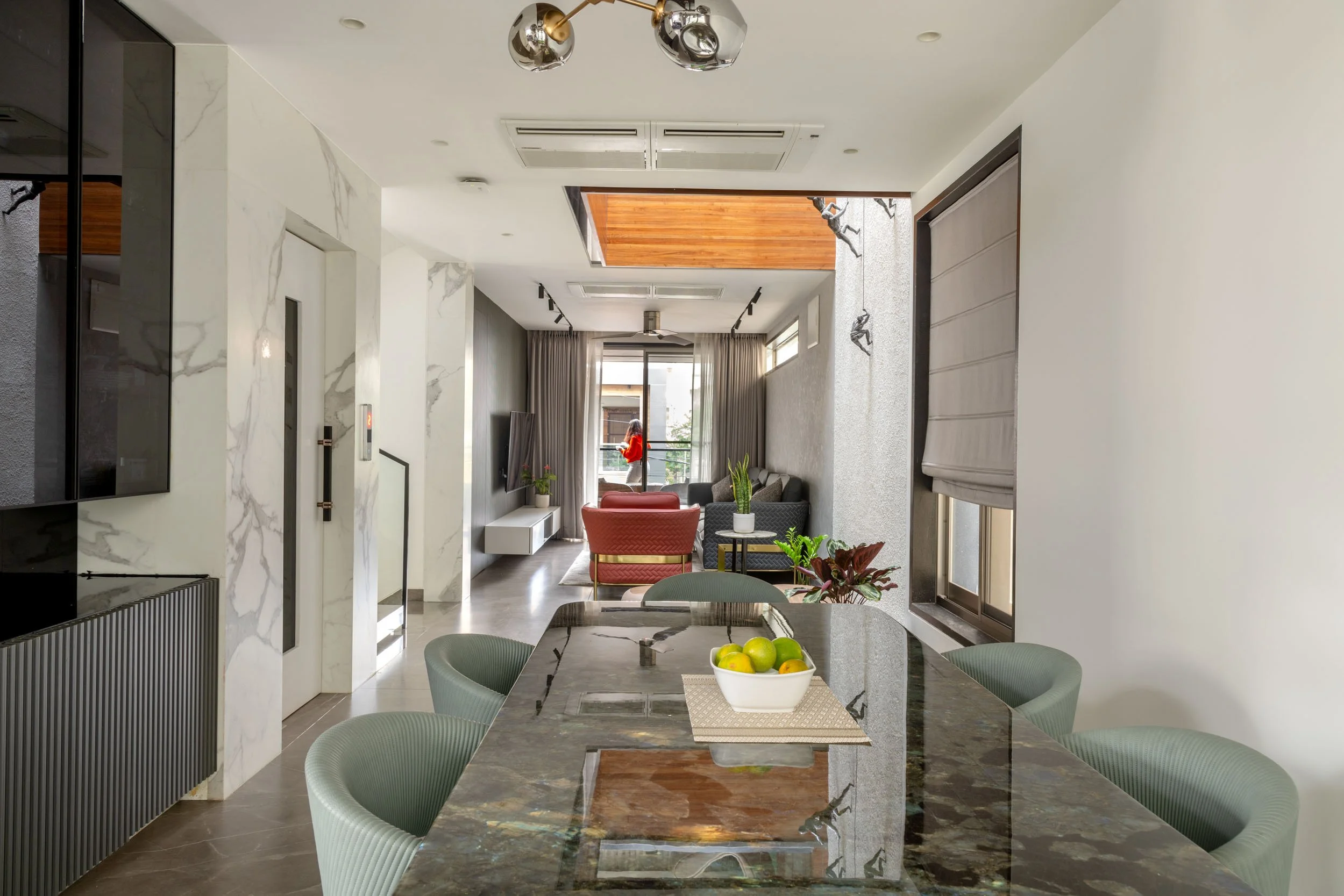 Professional interior photography of a modern residential dining area, highlighting an open-plan layout, elegant lighting, and a seamless indoor-outdoor flow