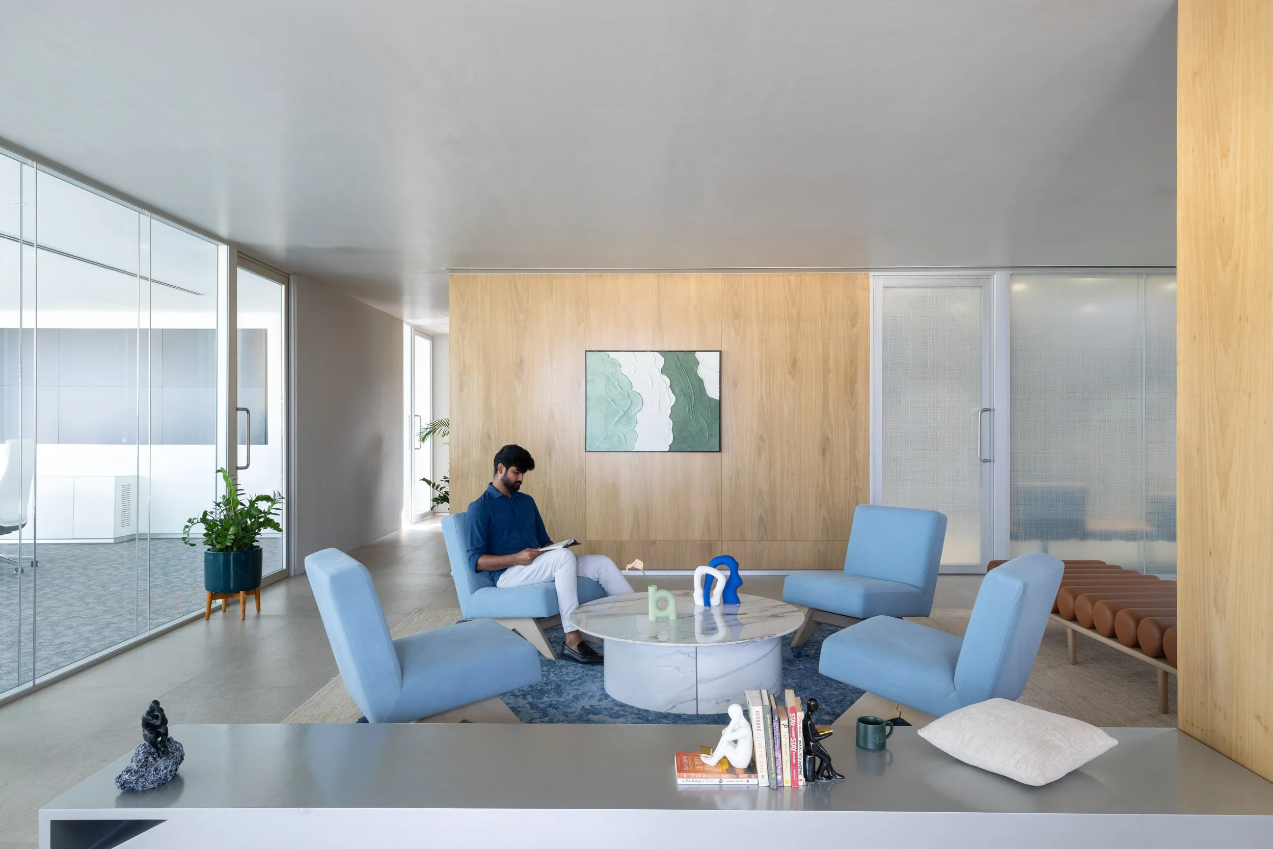 Commercial interior photography showcasing a bright corporate lounge and breakout space, highlighting comfortable seating arrangements, natural lighting, and contemporary architectural wood accents