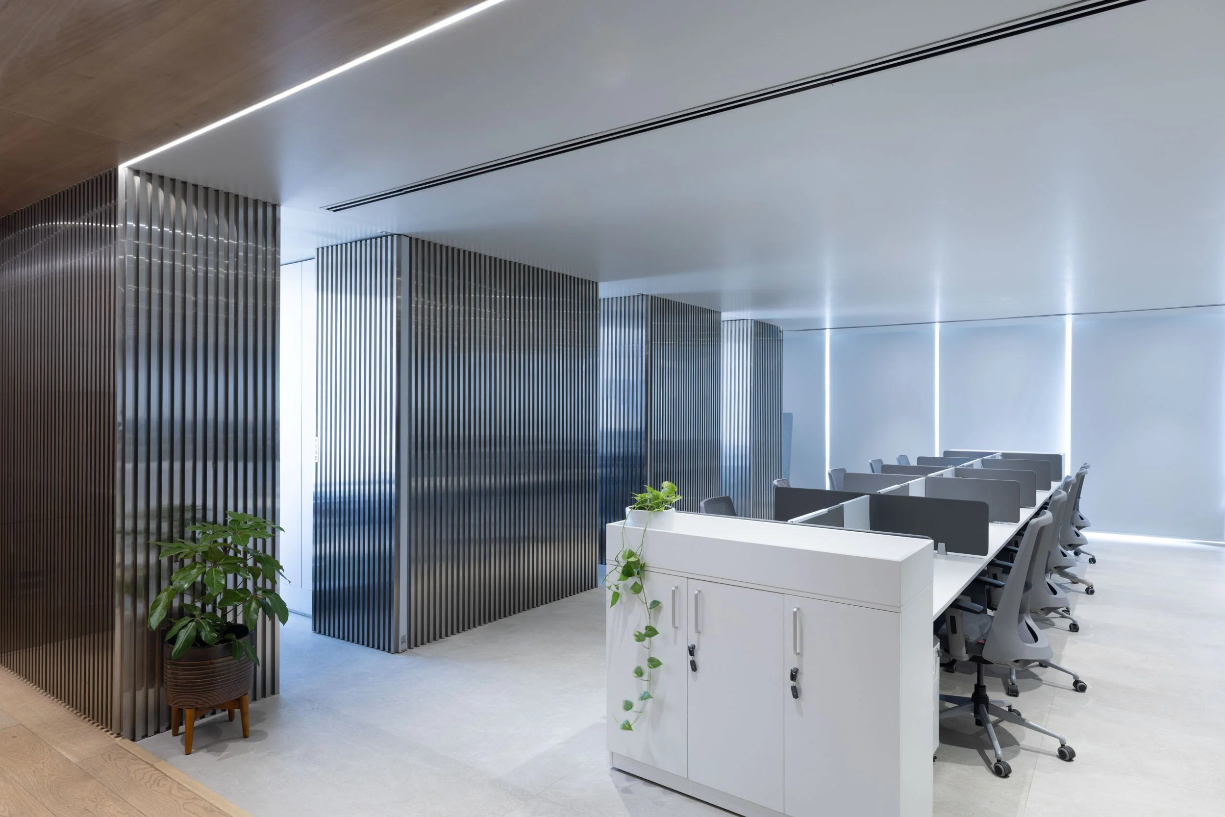 Commercial interior photography showcasing a modern corporate reception area, highlighting sleek architectural dividers and contemporary workspace design