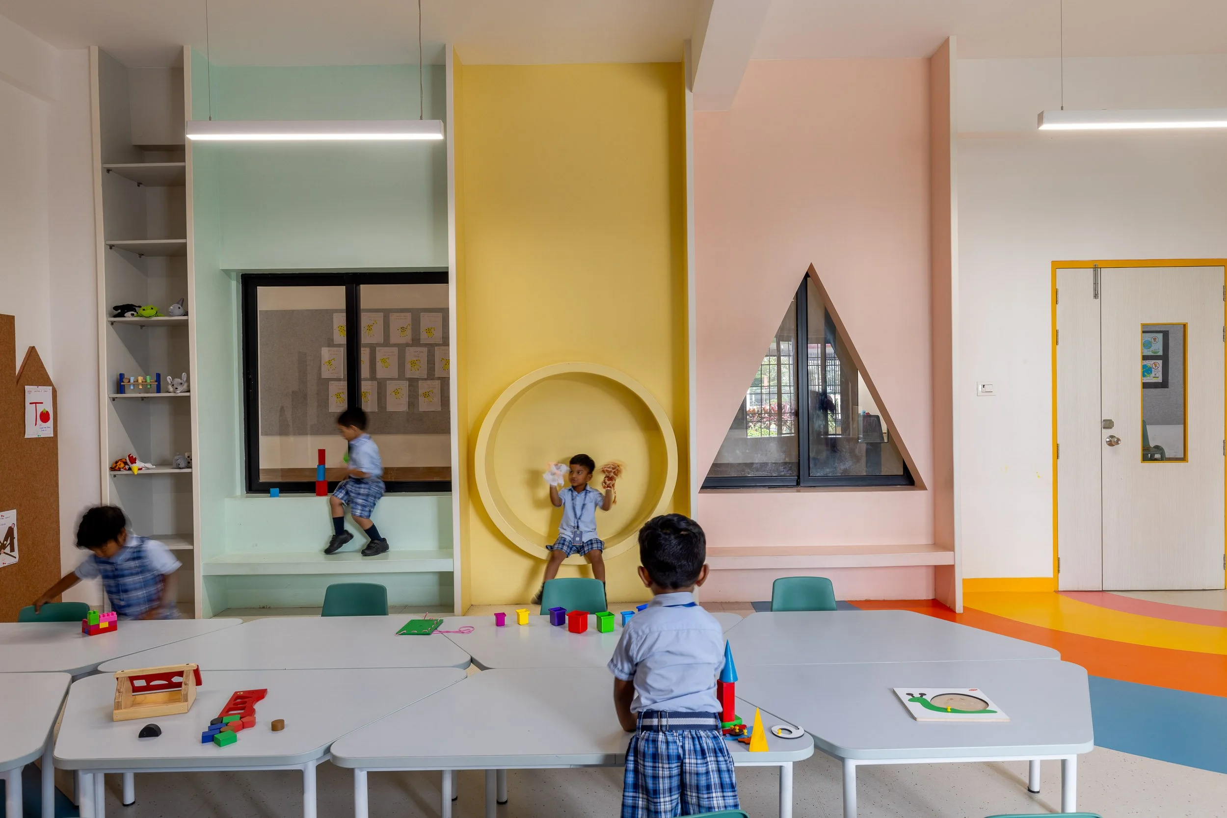 Interior school photography highlighting playful geometric architecture and bright, colorful interior design in an early childhood education center