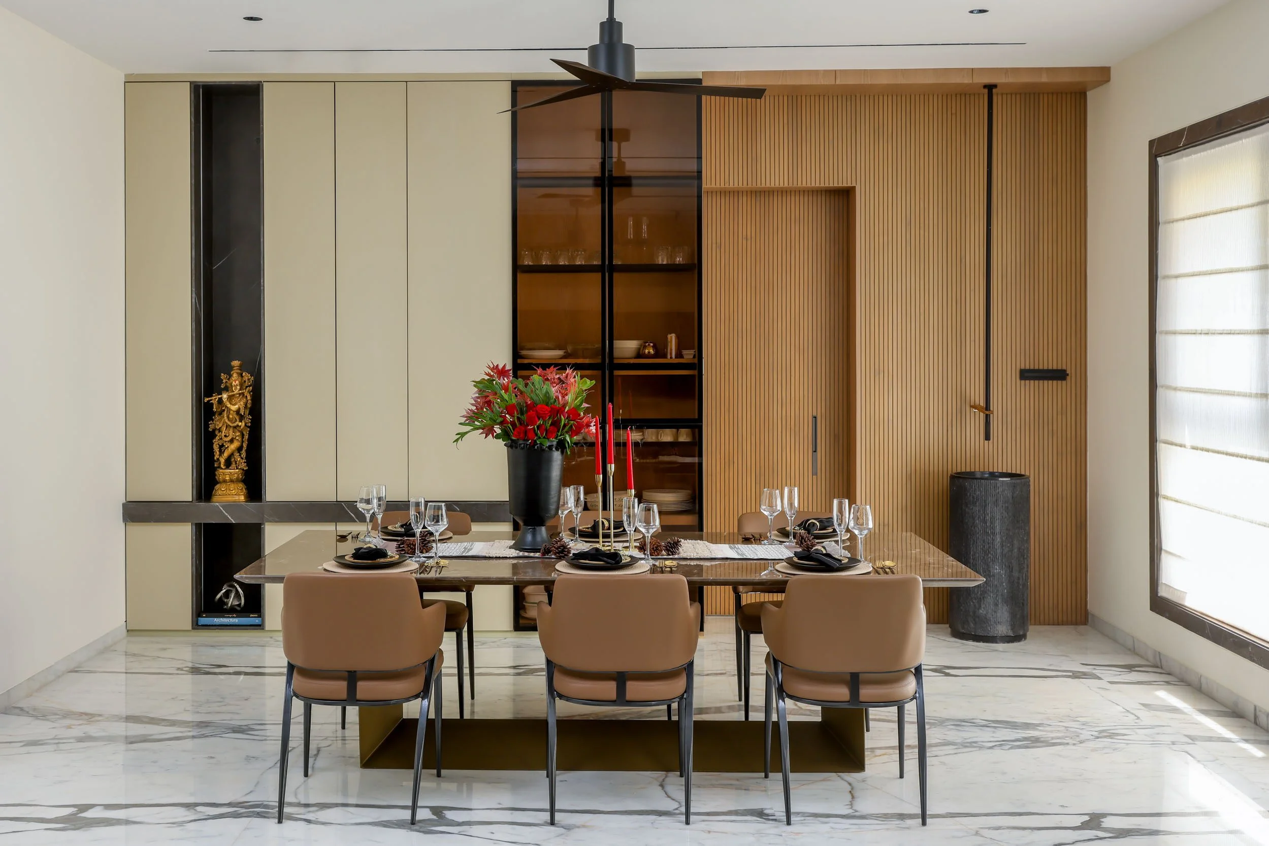 Professional interior photography of a modern residential dining room featuring custom wood paneling and built-in shelving