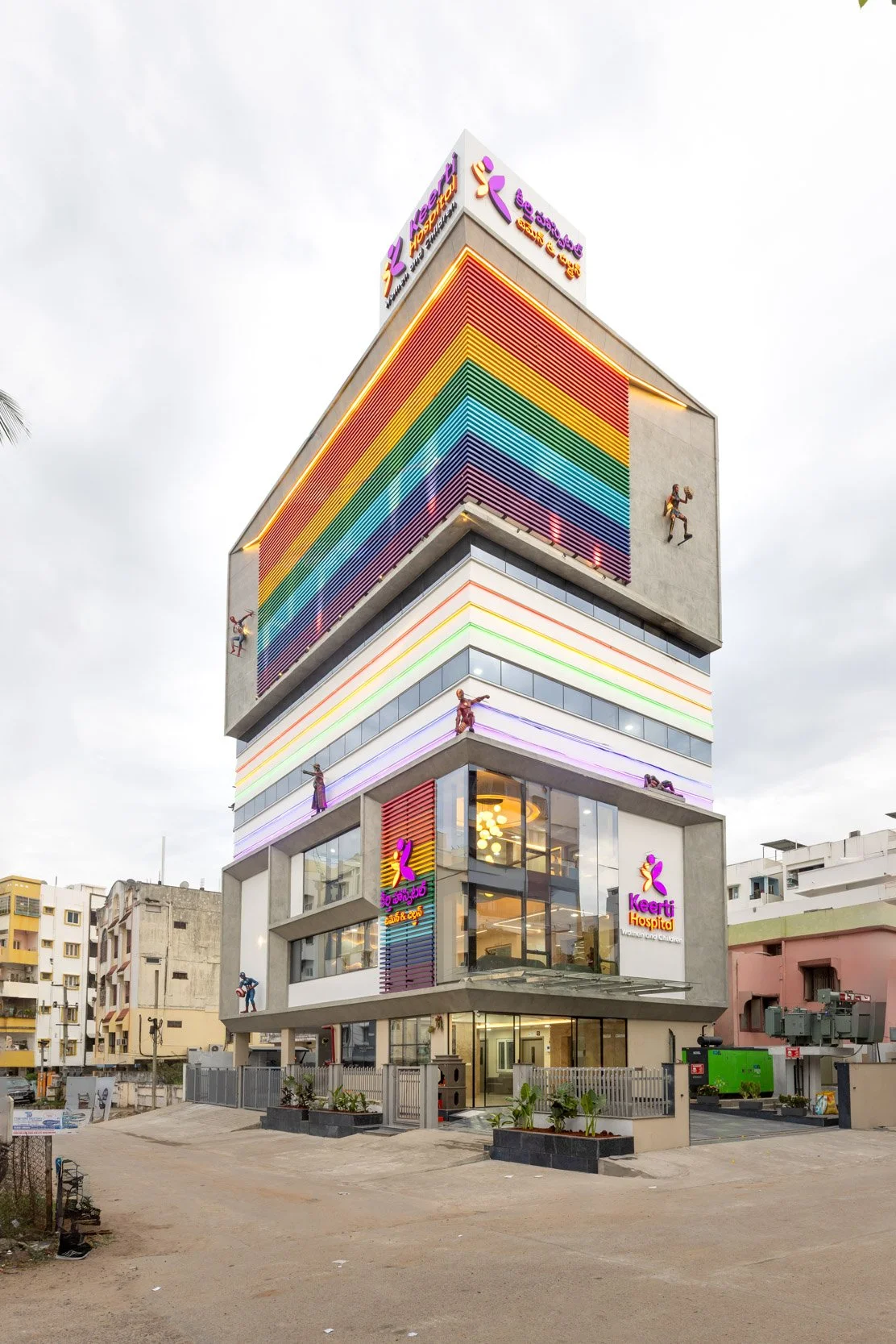 Commercial exterior architecture photography of a modern retail and office building, showcasing vibrant geometric facade details and urban integration.