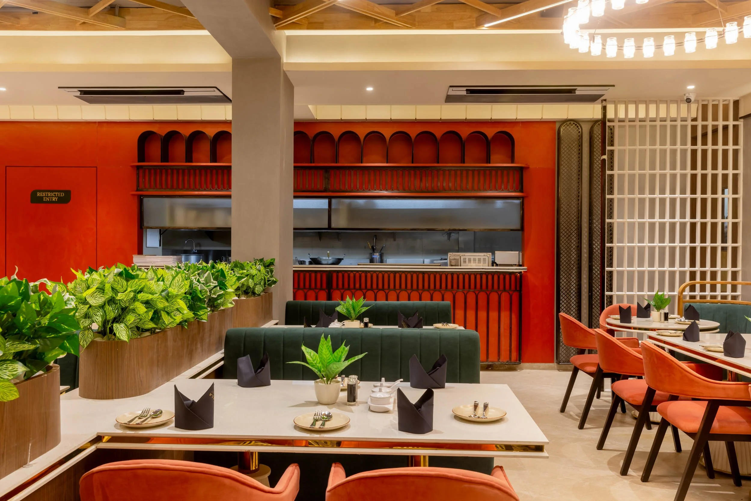 Commercial interior photography showcasing a vibrant modern restaurant design, highlighting colorful hospitality seating arrangements, custom wood ceilings, and dynamic dining spaces