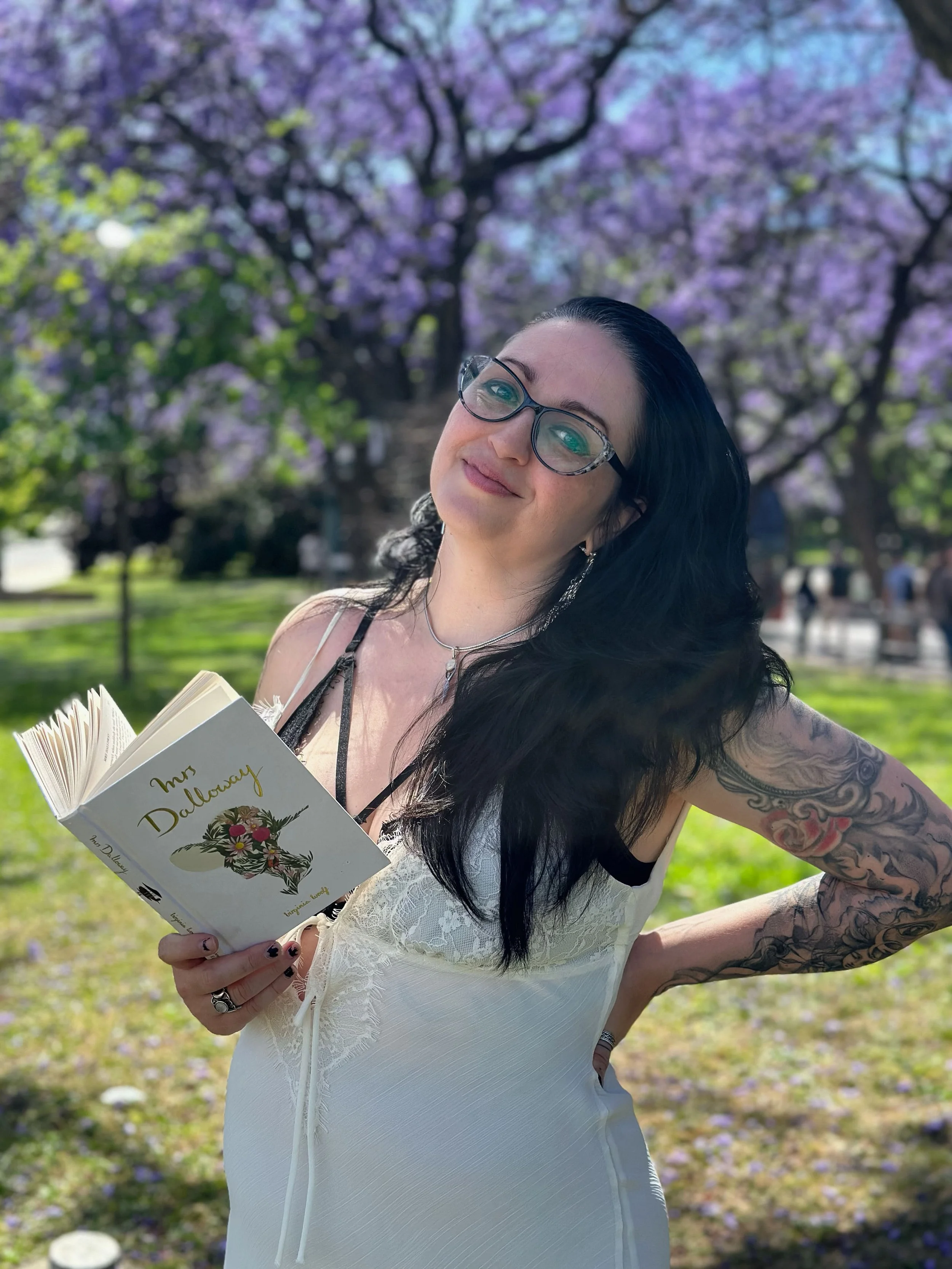 Elisa reading Mrs. Dalloway beneath a flowering Jacaranda tree in Lisbon