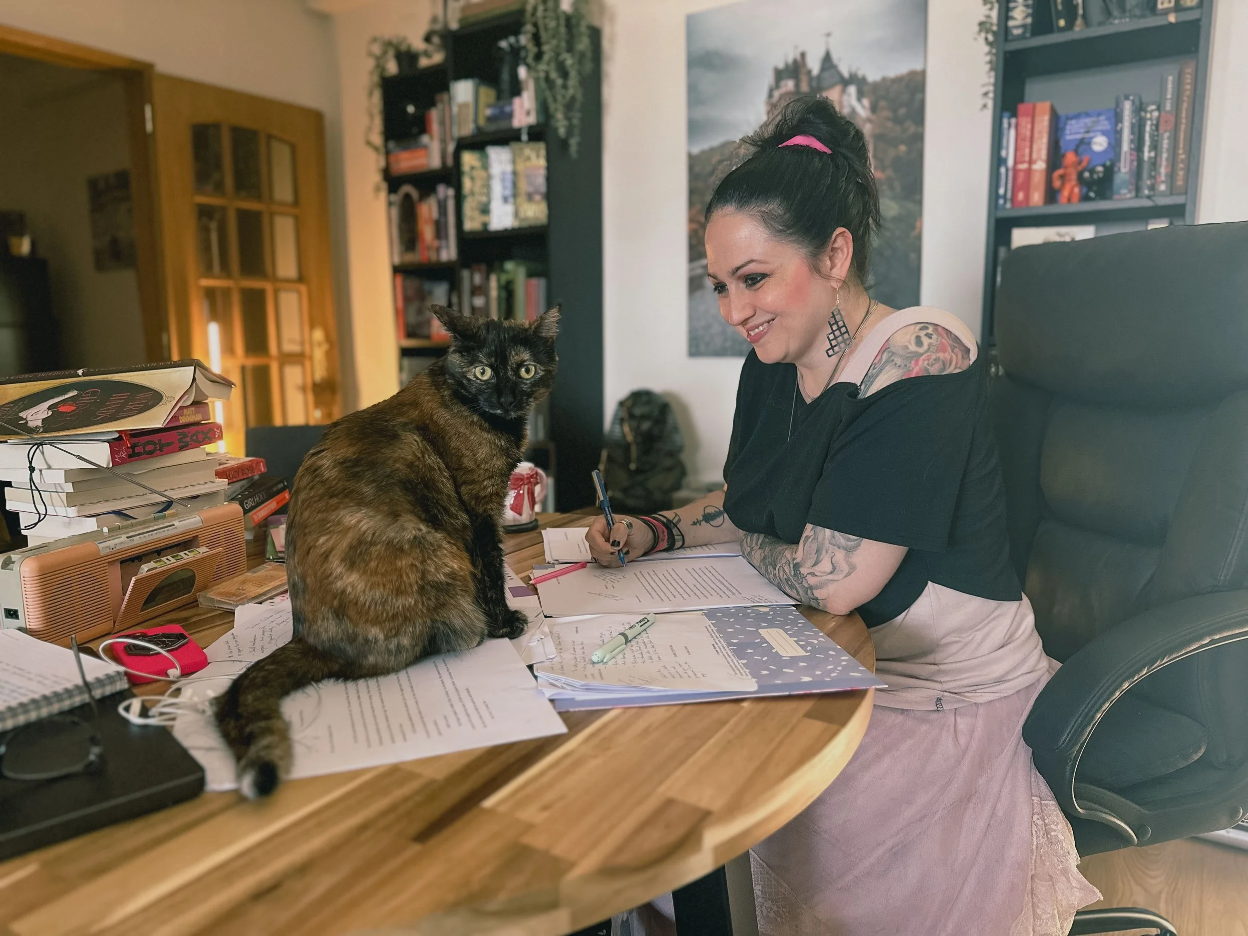 Elisa of Grace Editorial and her cat Freya working on a manuscript