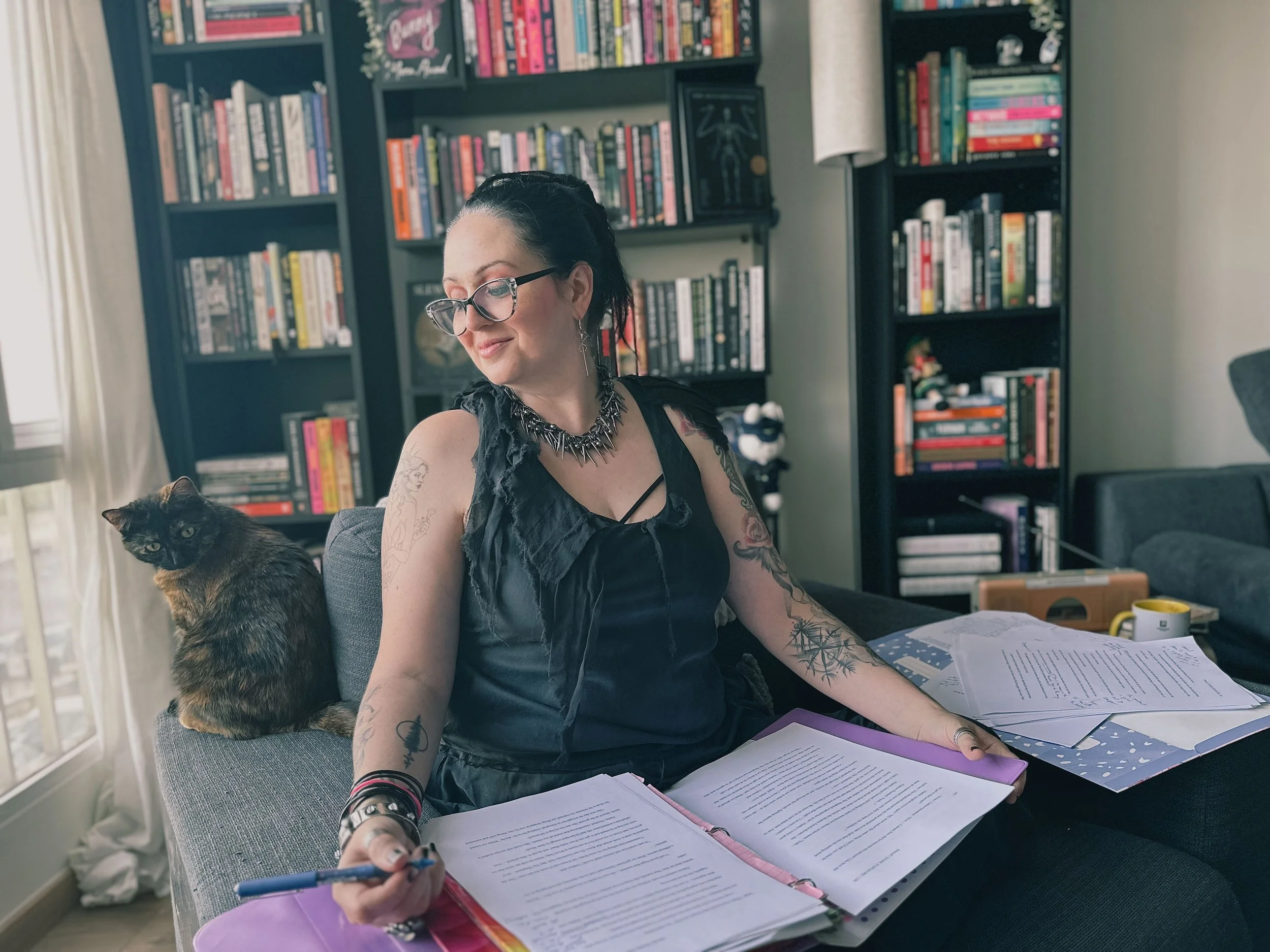 Elisa of Grace Editorial and her cat Freya working on a manuscript