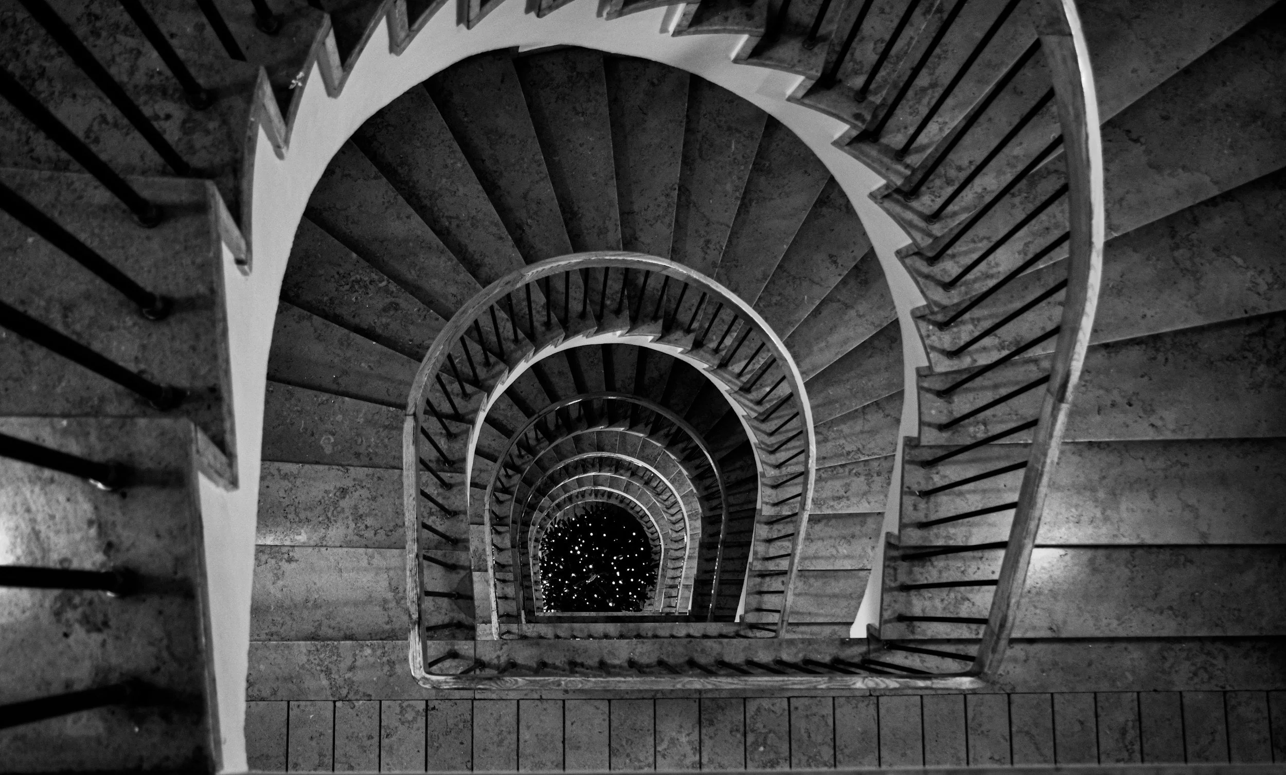Spiral staircase descending into darkness, representing pressure, focus, and internal awareness