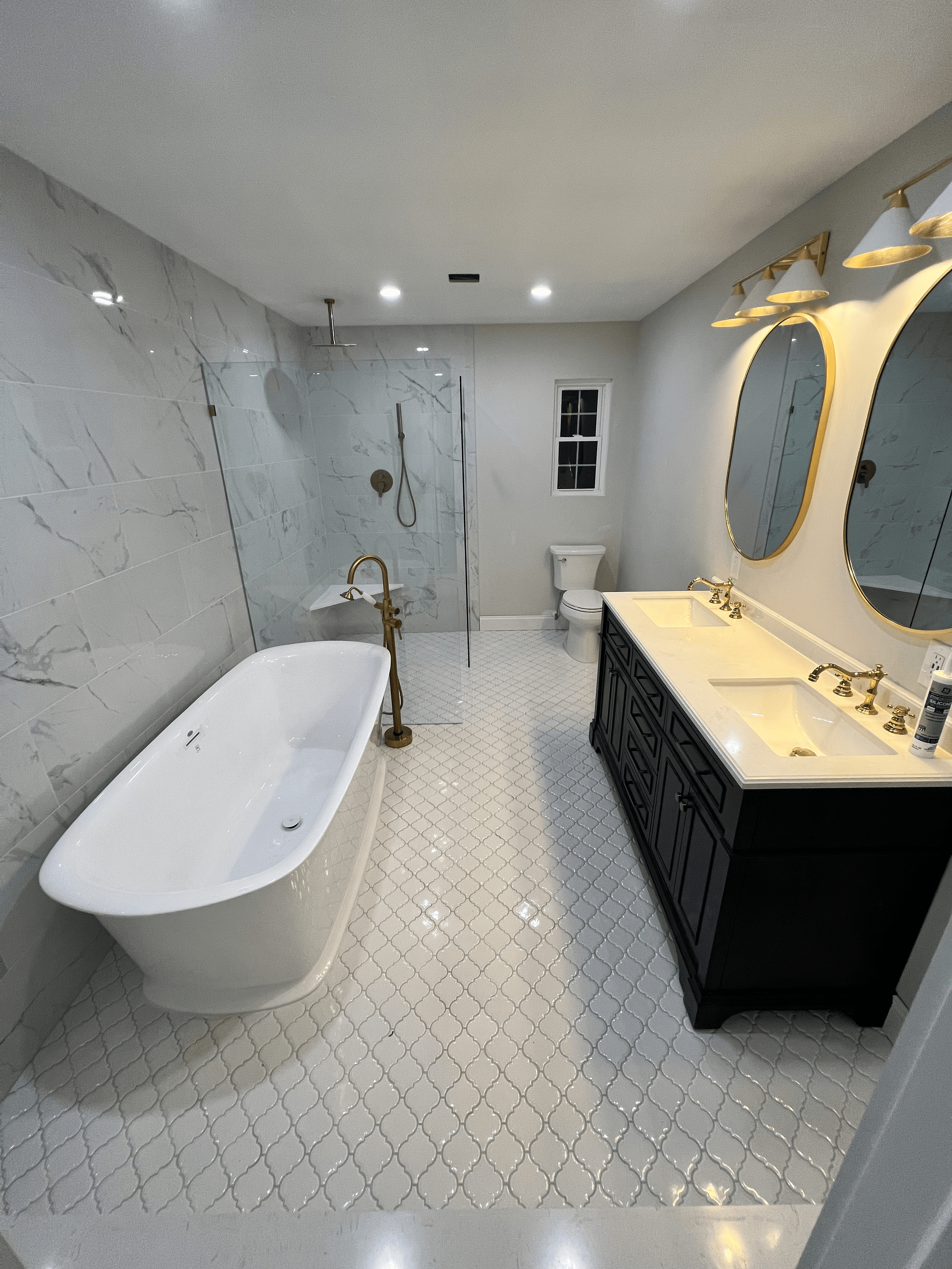 Bathroom remodel with custom vanity cabinetry, Calacatta quartz countertop, modern fixtures, and premium tile finishes, Southampton New York