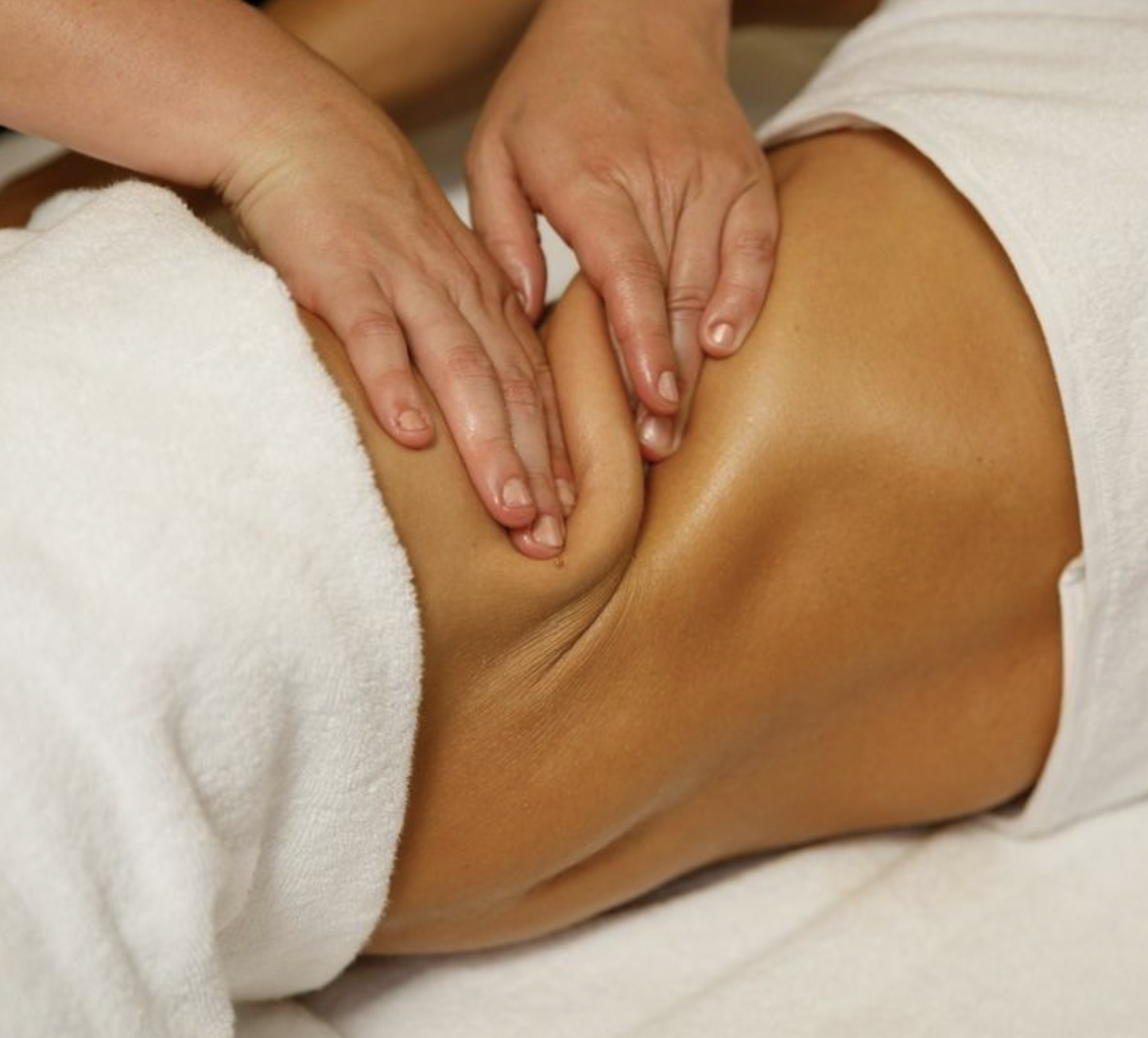 razilian Lymphatic Drainage massage performed manually on the abdomen to support lymphatic flow and fluid retention at The Beauty Sculpt in Marylebone, London.