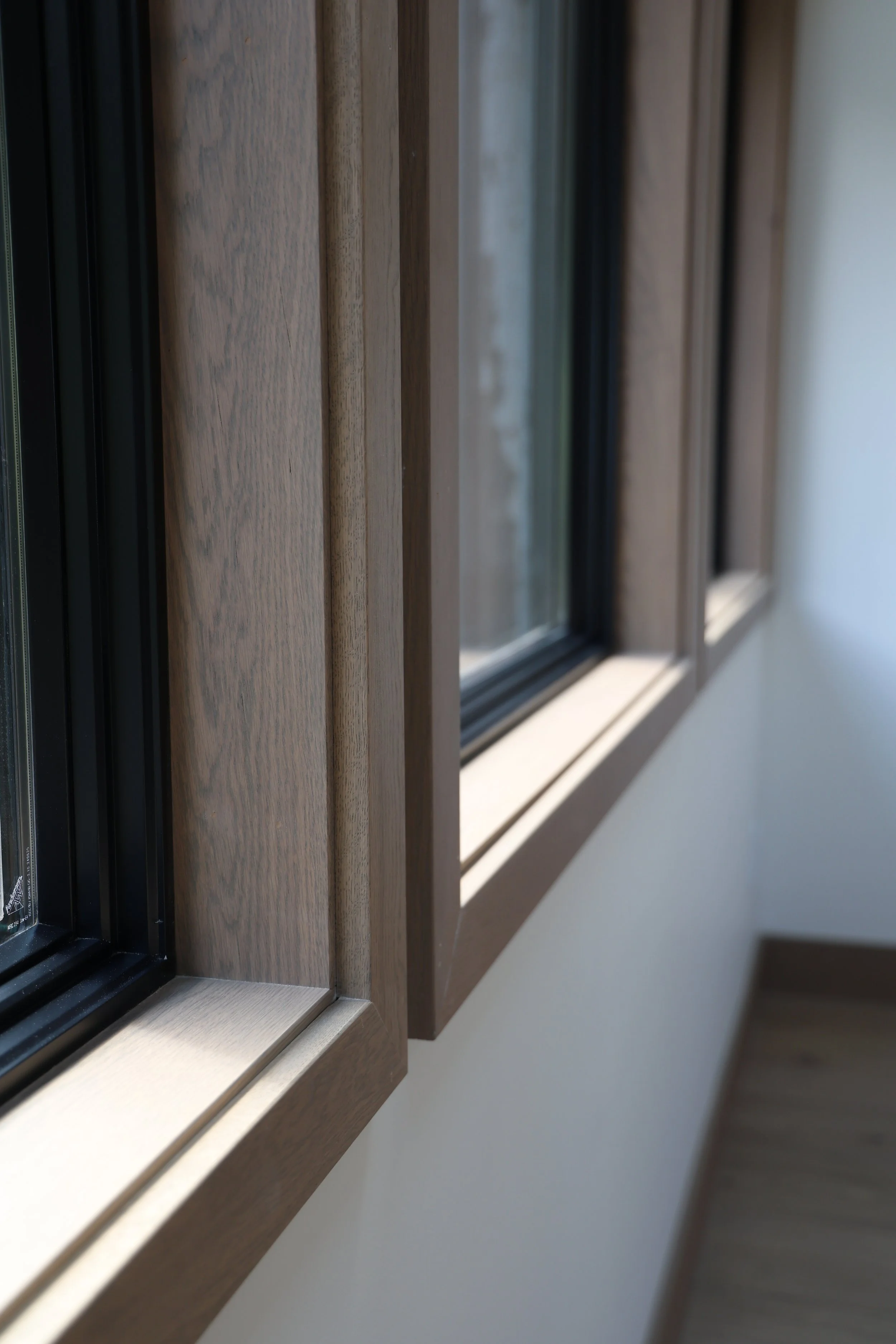 Close-up view of a window with a custom wooden frame in Ellicottville, NY..