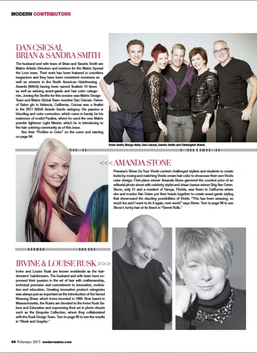 Group photo of five individuals, four men and one woman, standing together indoors, smiling, with a plain background.