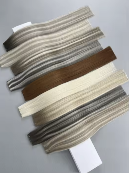 Various color swatches or sample strips arranged on a flat surface, displaying different shades of neutral and earth tones, likely used for interior design or fabric selection. In stock hair extensions near Orlando Florida