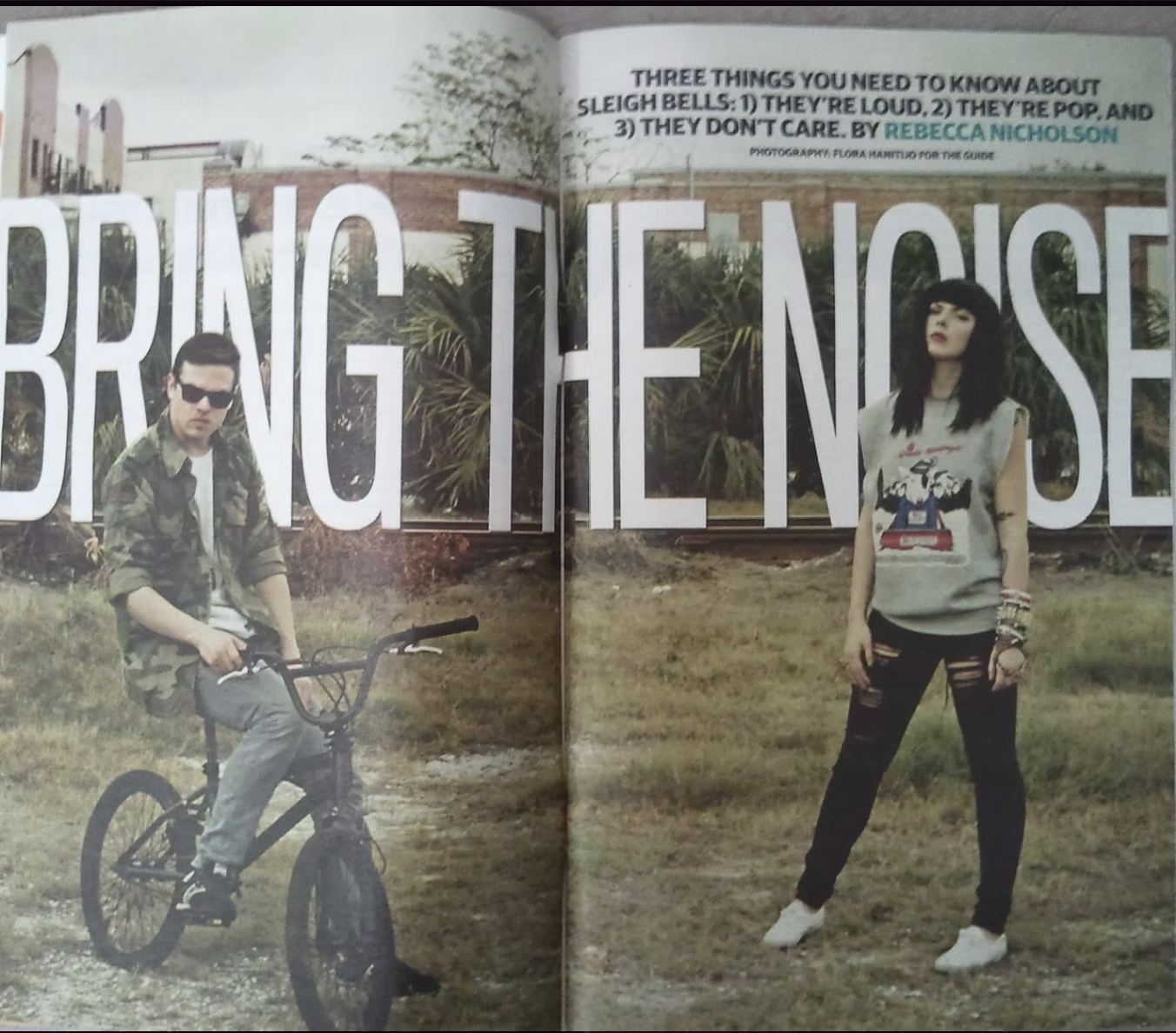 A magazine spread featuring a young man on a bicycle and a young woman standing outdoors in front of large text that reads "BRING THE NOISE." The layout includes a small paragraph with tips about sleigh bells and credits for the guide.