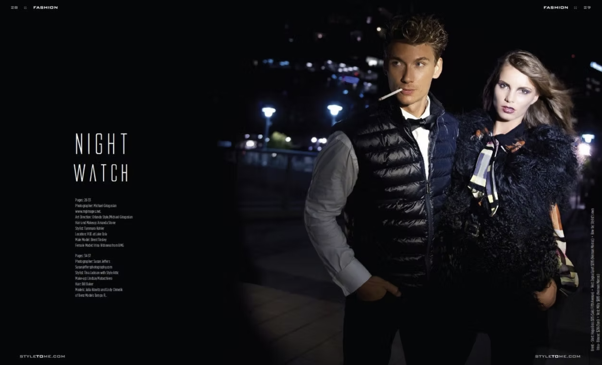 A man and a woman standing together outdoors at night, dressed in stylish clothes. The man has a cigarette in his mouth and wears a black puffer vest over a gray shirt. The woman has flowing hair and wears a black textured coat with a patterned scarf