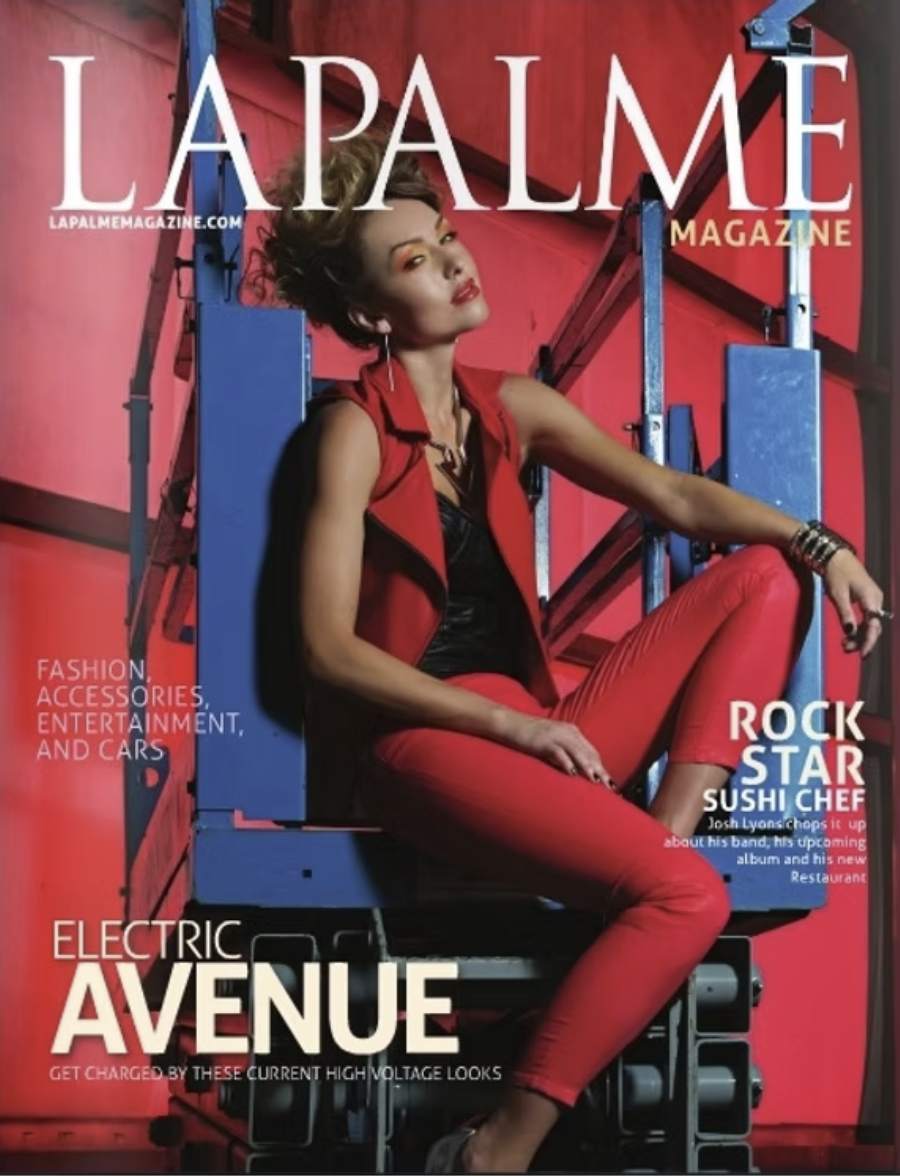Cover of La Palme Magazine featuring a woman in red pants and a sleeveless red jacket sitting on a blue electrical box, with magazine headlines about fashion, accessories, entertainment, and a sushi chef.