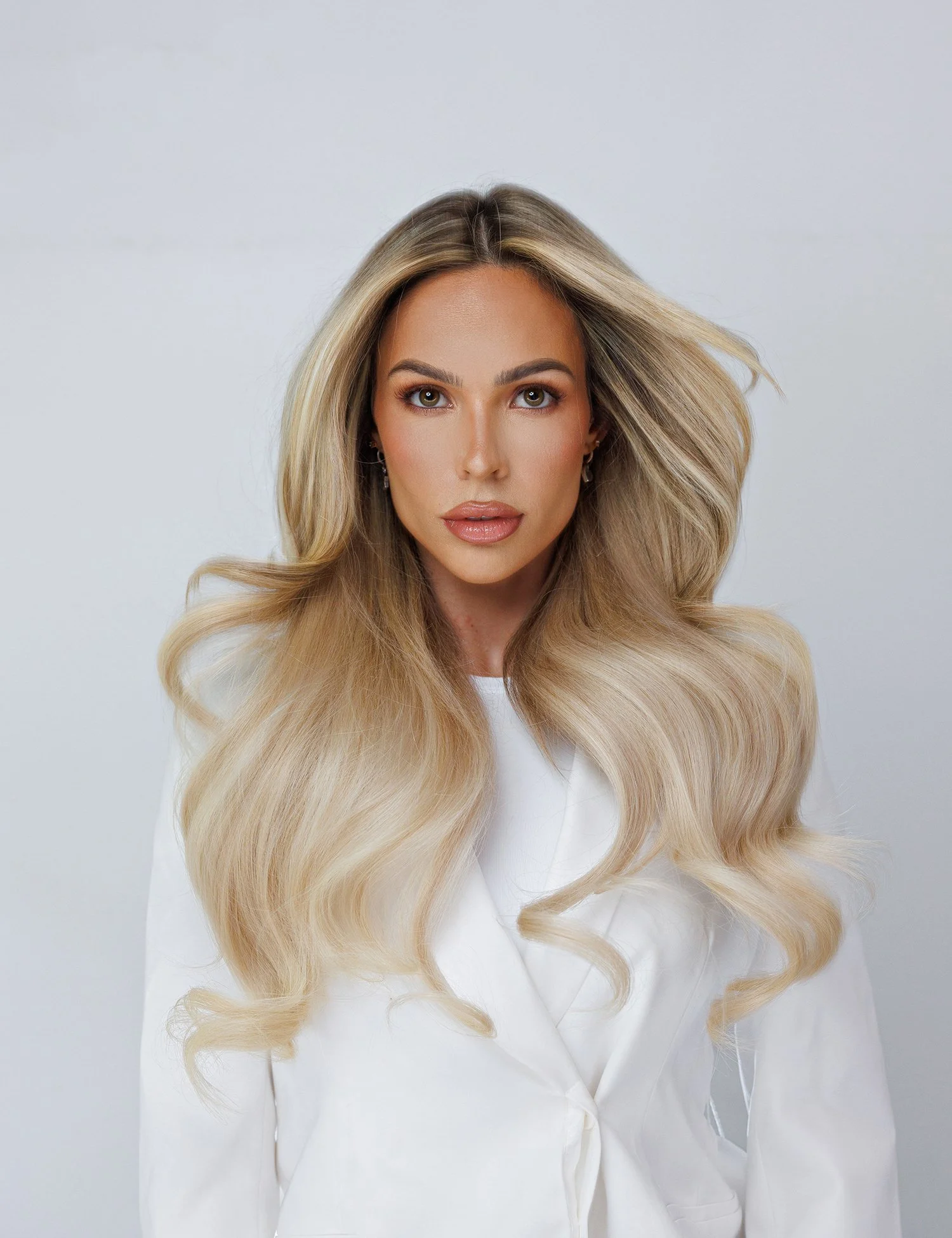 Luxury hair extensions in Orlando with long seamless blonde hair transformation at Amoura on WWE superstar Maxxine Dupris hairstylst in Orlando florida UCF