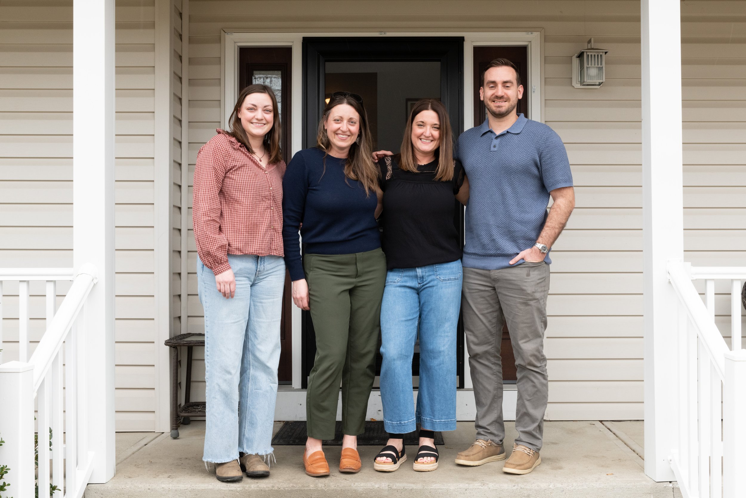 Four adult siblings, happy and healthy at home together.