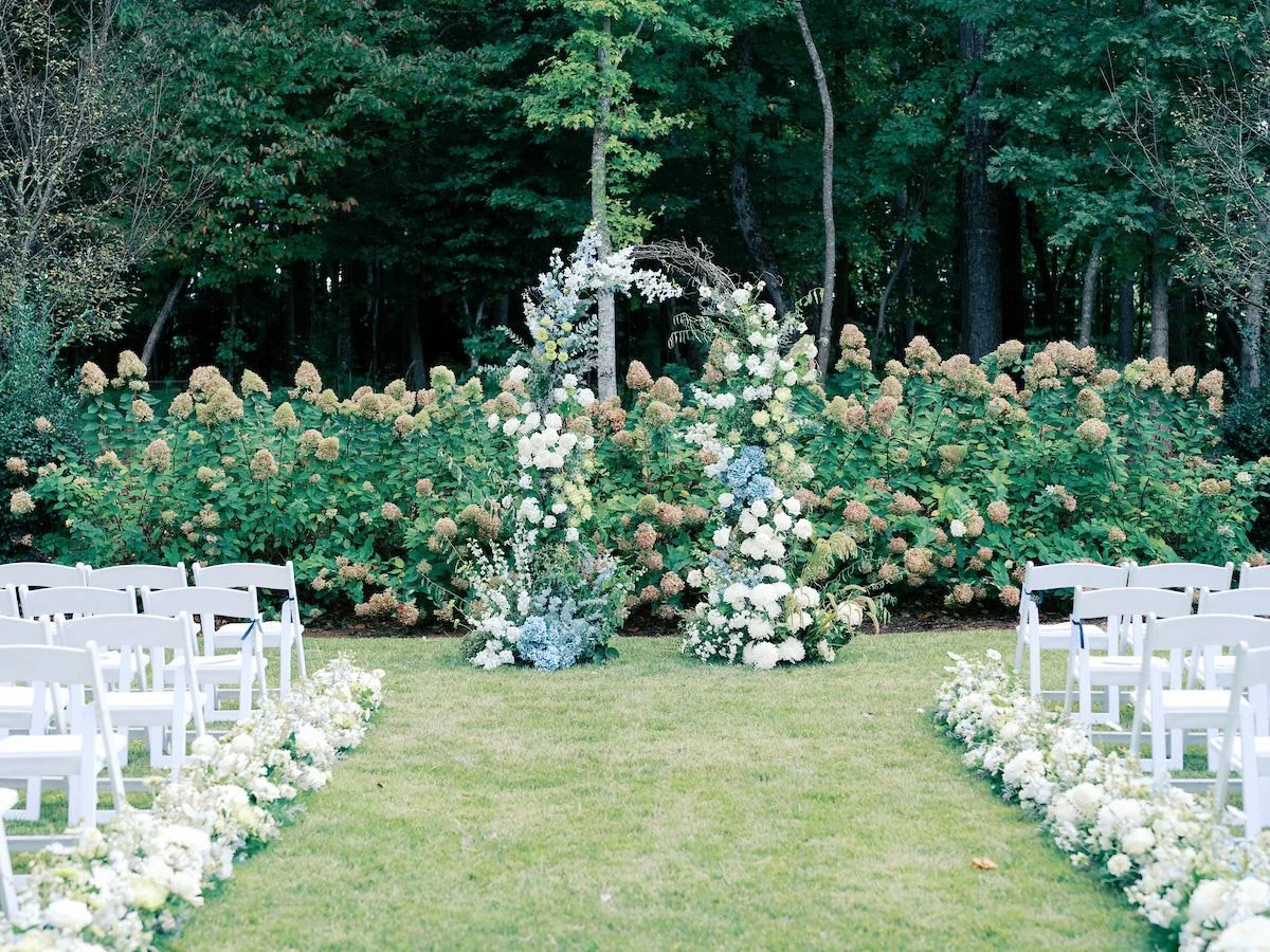 Garden ceremony floral installation with white flowers and greenery at The Barn of Chapel Hill wedding venue