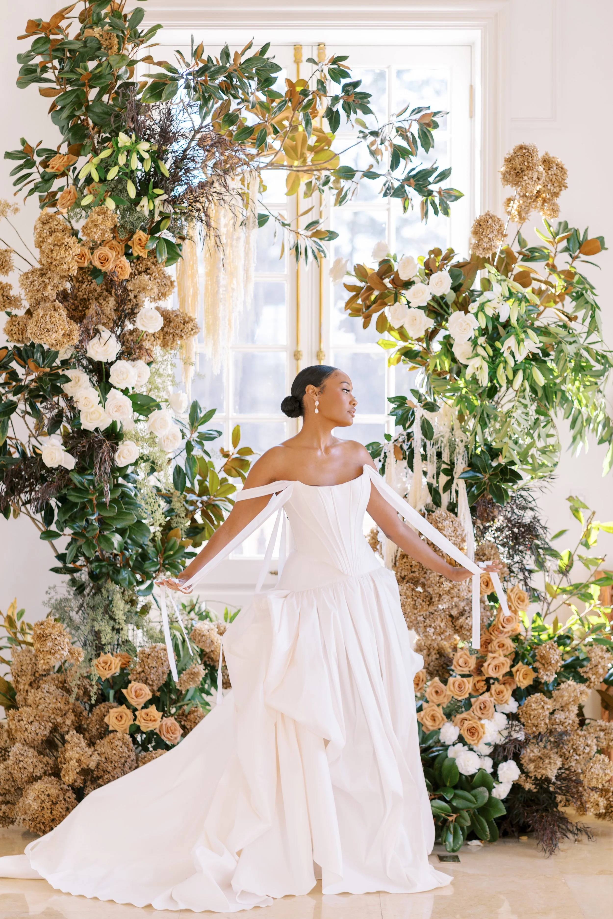 Bride with Asymmetrical Floral Arch in Background, Modern Romance