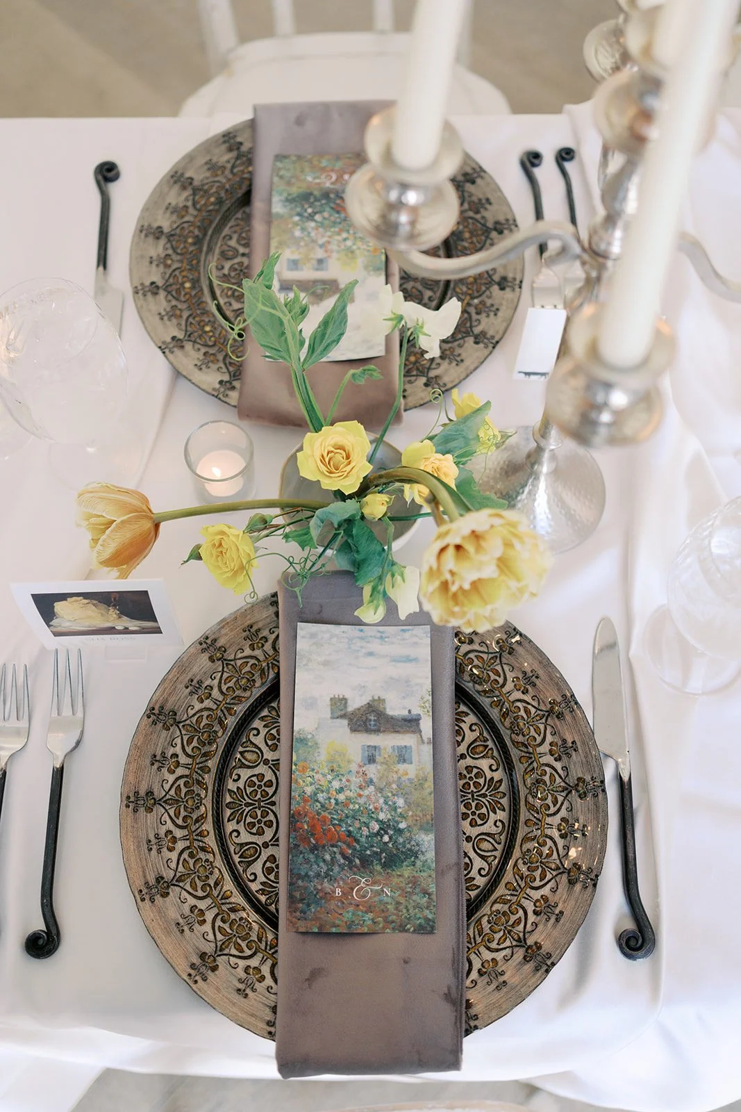  Art-inspired place setting with ornate gold chargers, yellow garden roses and parrot tulips, and an Impressionist menu card at The Bradford   