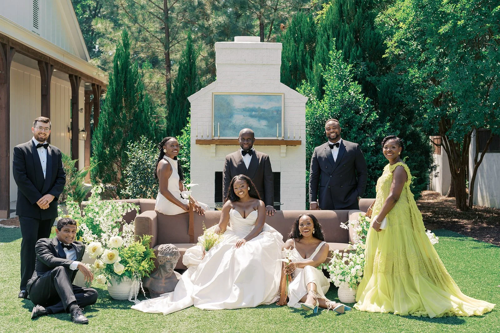 Wedding party at the outdoor fireplace lounge with white and green florals at The Bradford