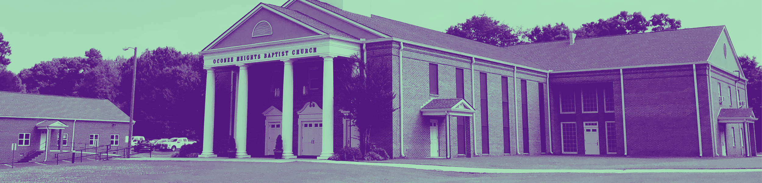 A large church building with a prominent portico supported by four white columns, labeled "OConne Heights Baptist Church," surrounded by trees and parking lot.