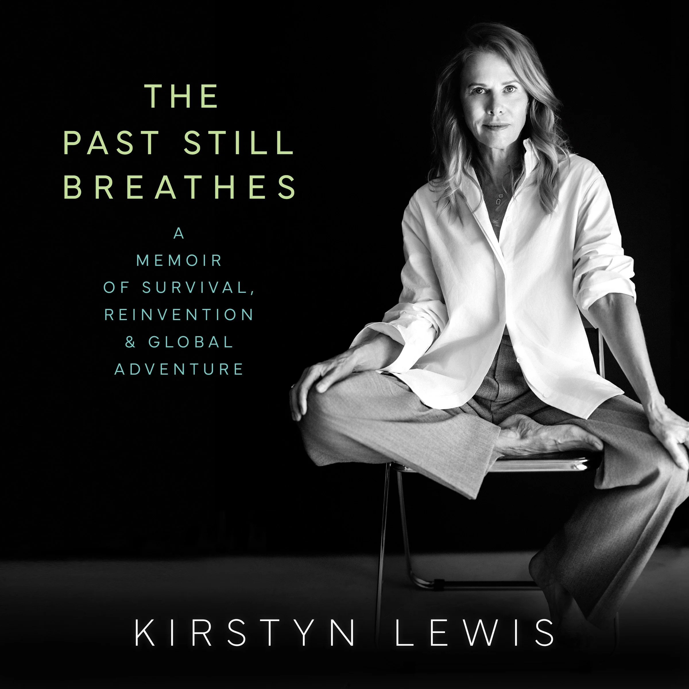 Book cover of 'The Past Still Breathe', a memoir by Kirstyn Lewis. The cover features a black and white photo of a woman sitting cross-legged on a chair against a dark background.