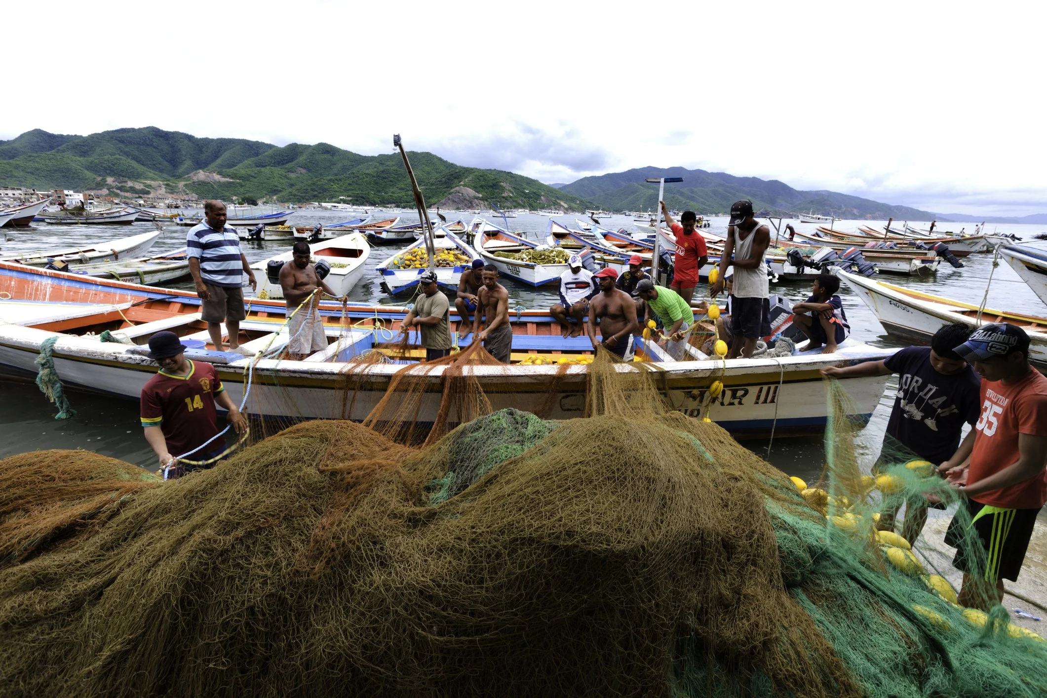 Carupano, Venezuela - September 16, 2011: Fishermen preparing nets and boats to fishing. Morning work from a community dedicated to artisan fishing.