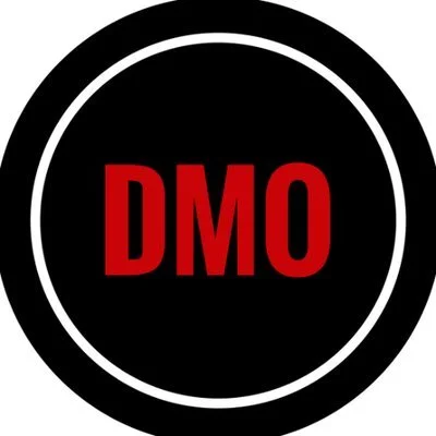 Black circular badge with red letters 'DMO' in the center, surrounded by white and black rings.