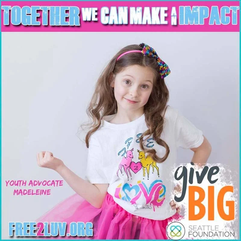 A young girl with long, wavy hair wearing a white t-shirt with colorful horse illustrations and a pink tutu skirt. She has a rainbow beaded bow in her hair and is posing with her arm flexed. The background has pink, blue, and purple text promoting yo