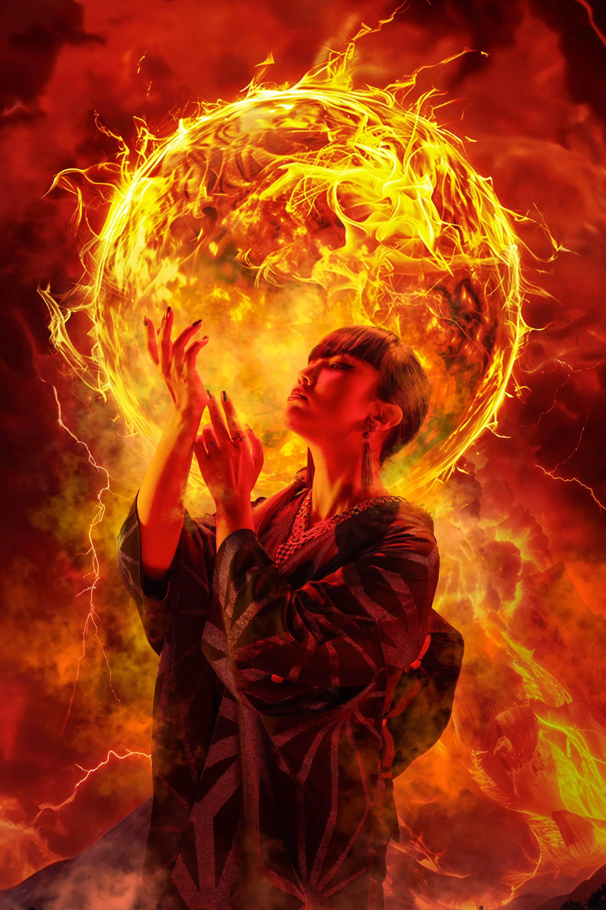 A woman with short dark hair and elaborate earrings is posing with her hands near her face against a fiery background of flames and lightning, with a large fiery sphere behind her.