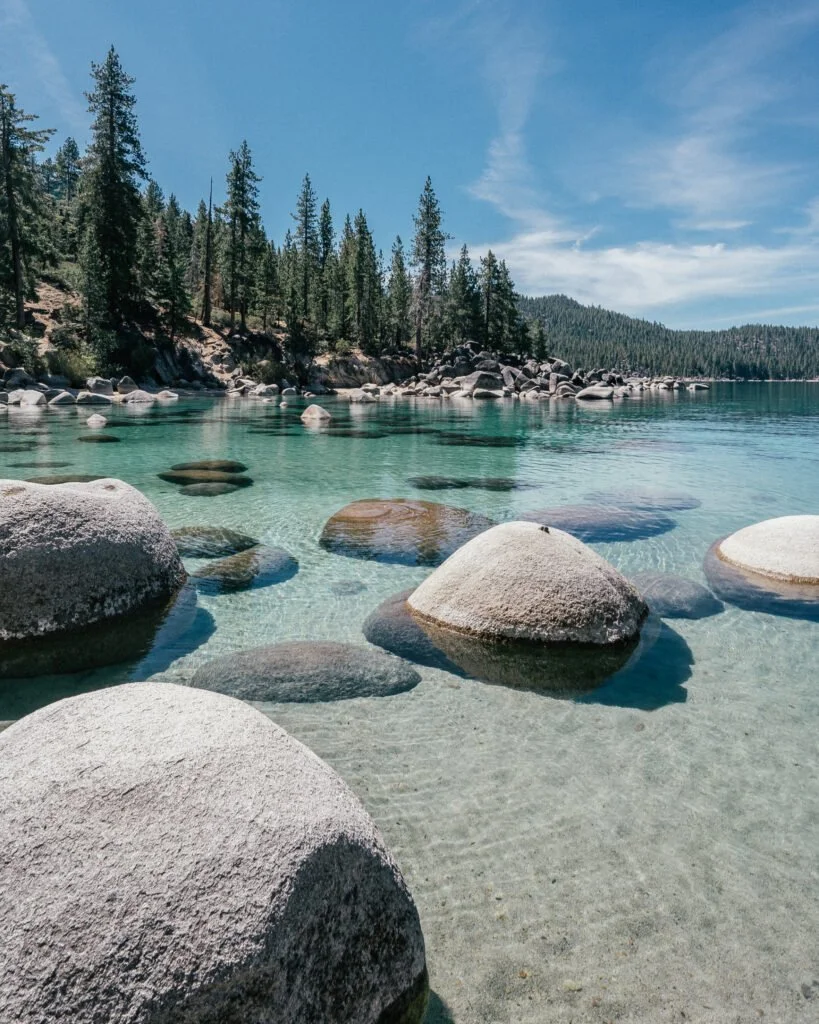 Crystal clear Lake Tahoe with granite rocks and pine trees — Reno Tahoe dining destination WhereRenoEats
