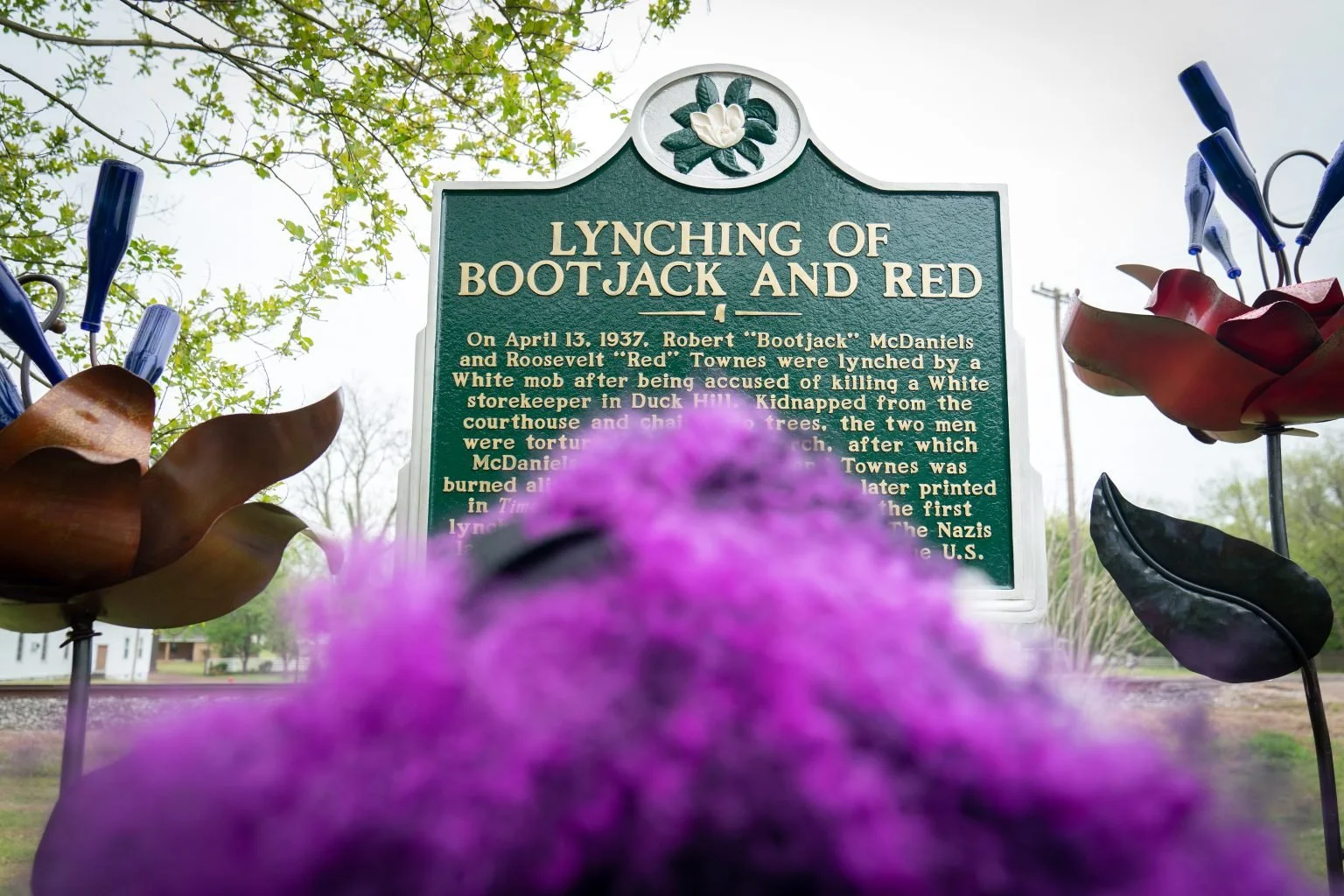 View of Talamieka Brice overlooking the historical marker for Bootjack and Red erected in the Duck Hill town square.