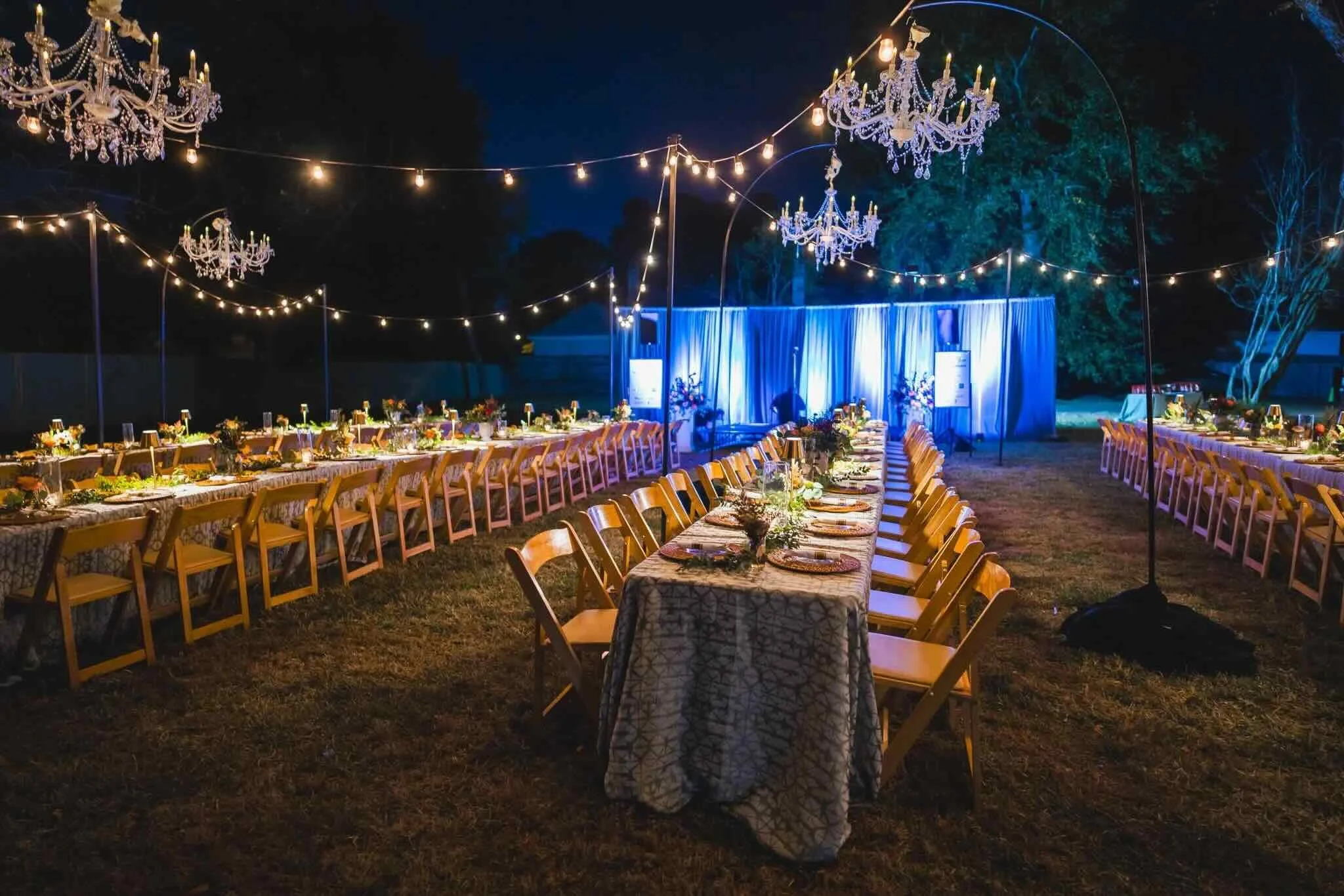CFM's Friendsgiving celebration is set outside with long community tables under lights. 