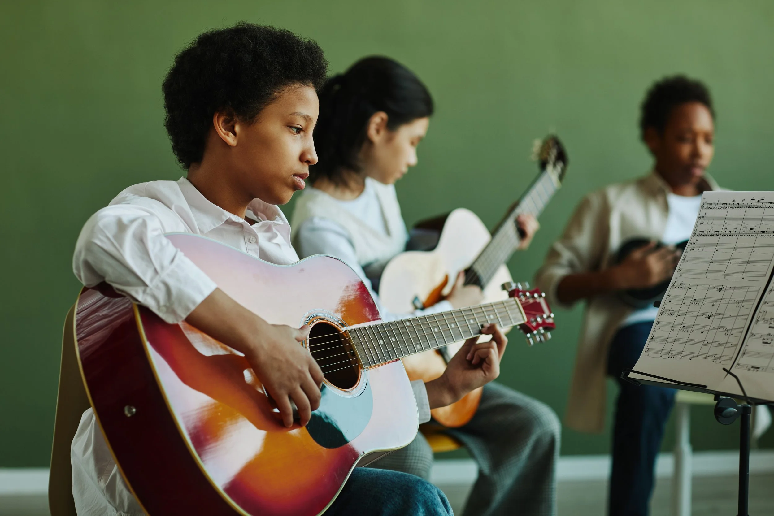 Teens playing guitar