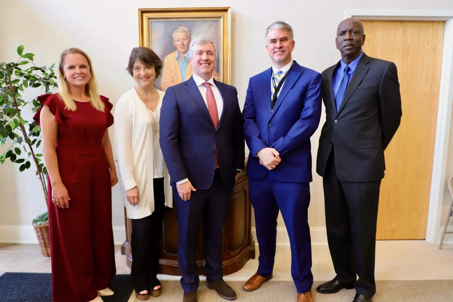 Multiple people pose together at Lifeshare House on the campus of the Mississippi Schools for the Deaf and Blind during a May 11, 2023 press conference.