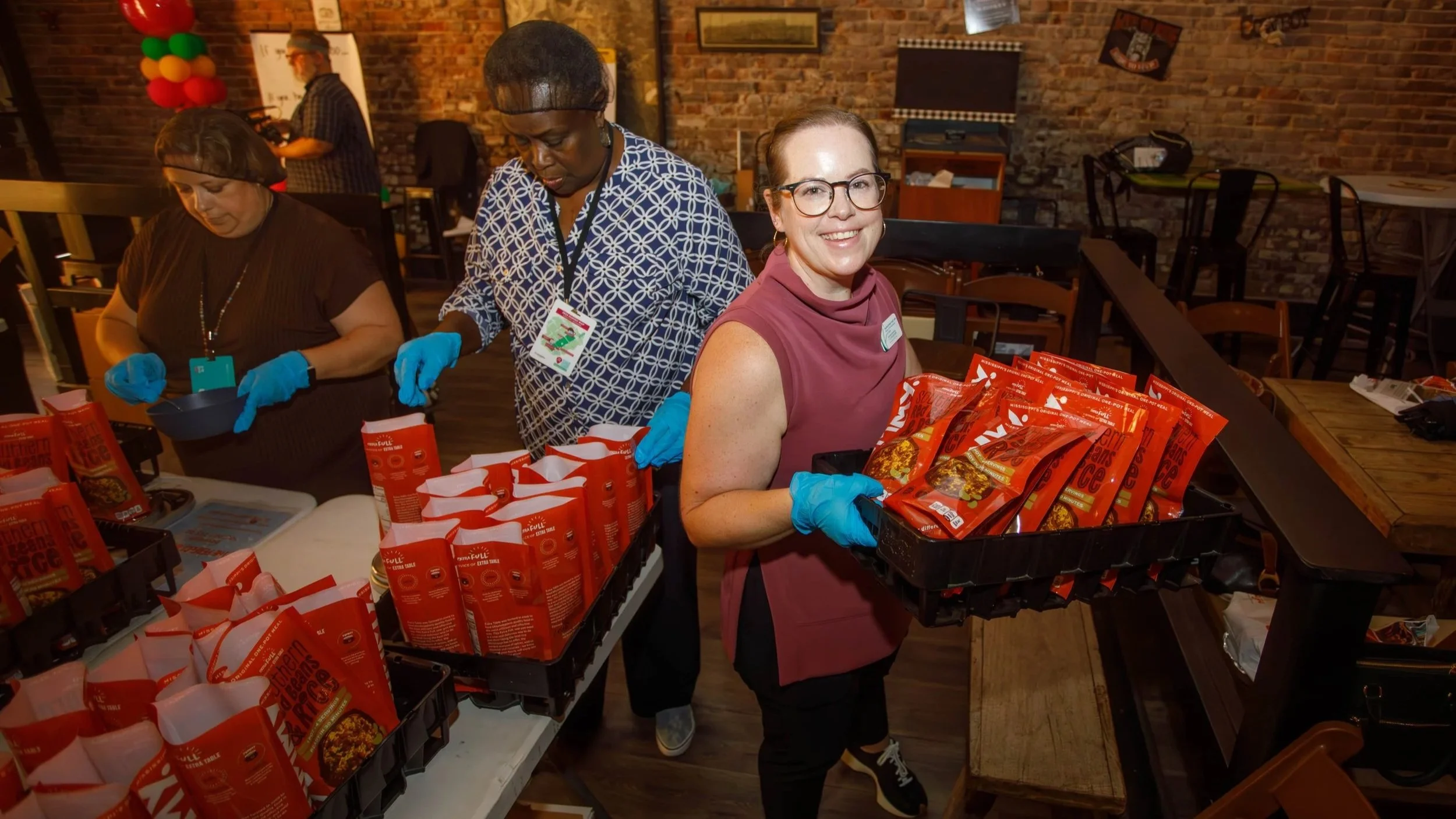 Sophie McNeil Wolf packs food the 2026 Rural Placemaking Summit in Yazoo City, MS.